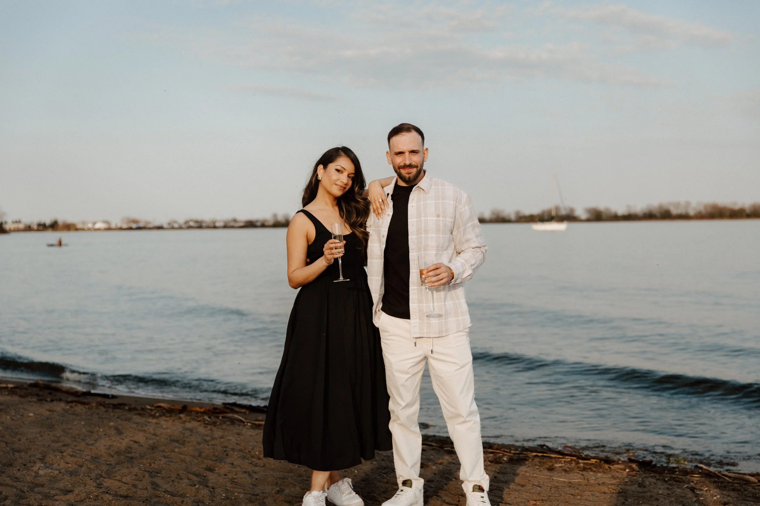 Couple photographed along the Toronto waterfront during golden hour