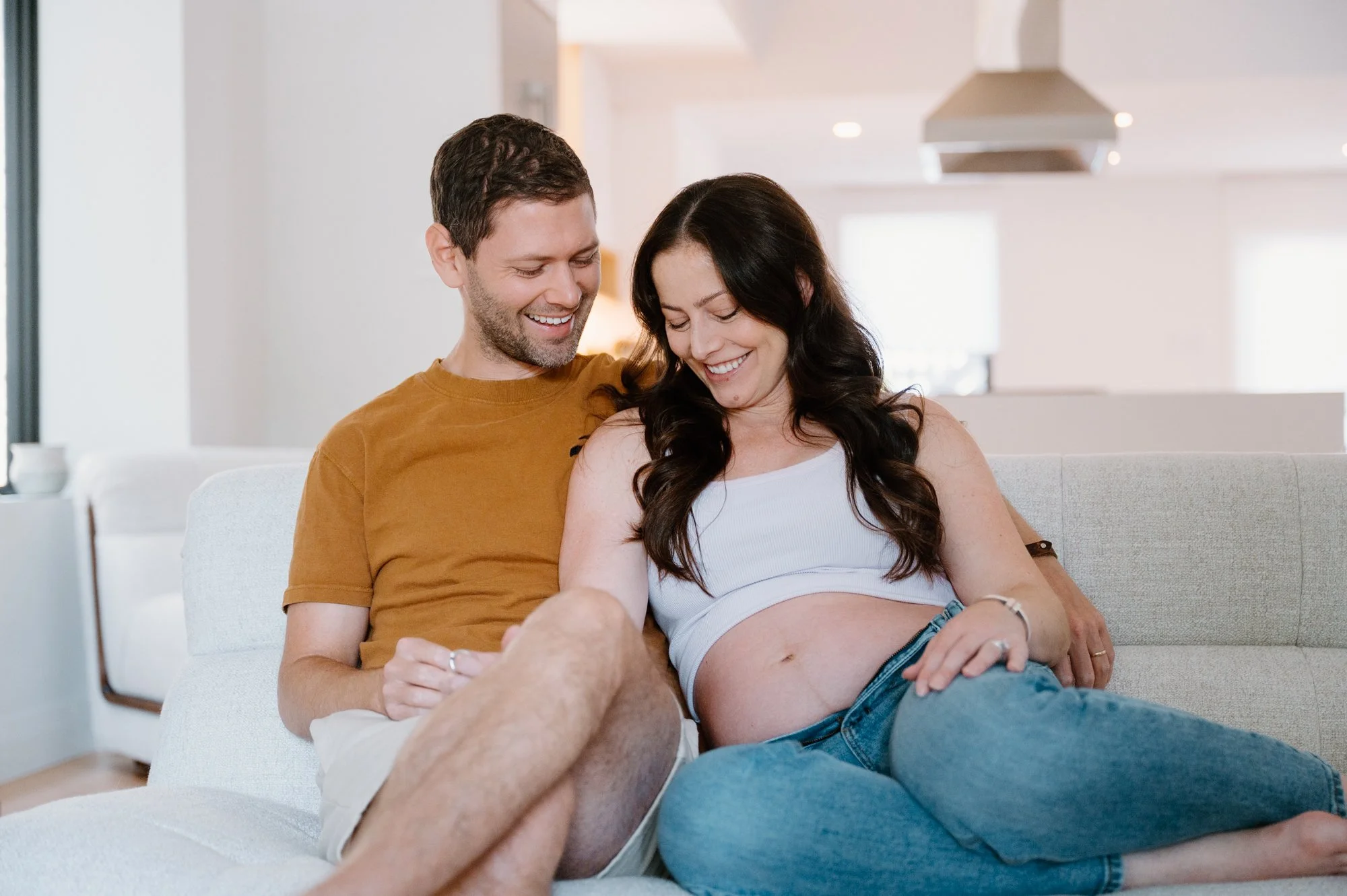 Candid close up of a couple during an at-home maternity session in their living room in Toronto