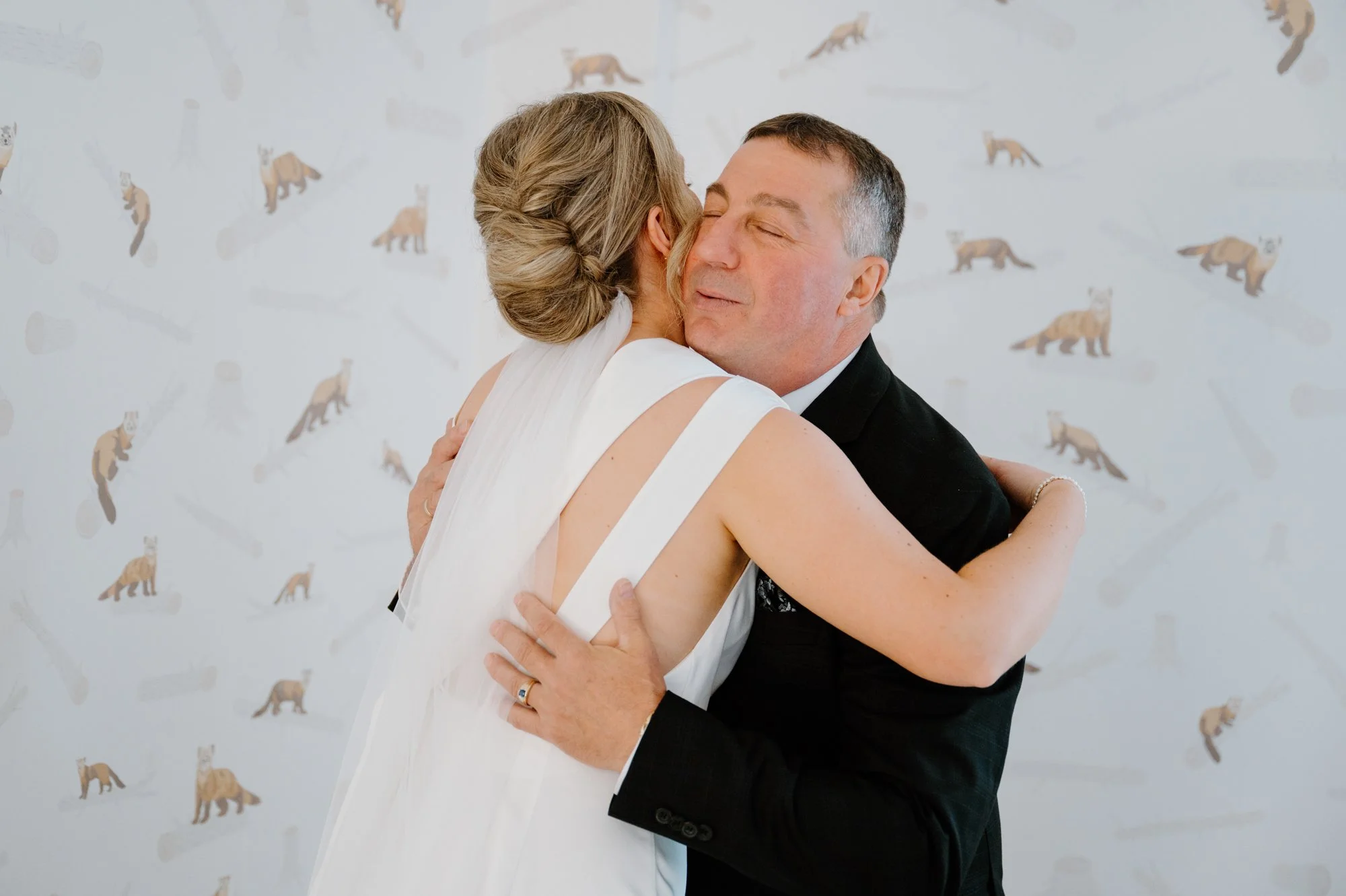 Candid emotional moment between a bride and her father during a first look at a destination wedding on Vancouver Island