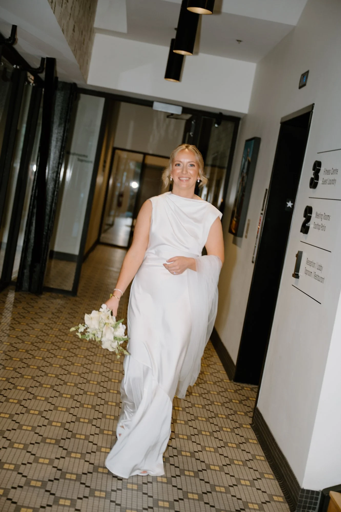 Editorial photo of a bride leaving the Hew and Draw Hotel in Corner Brook, Newfoundland on her wedding day