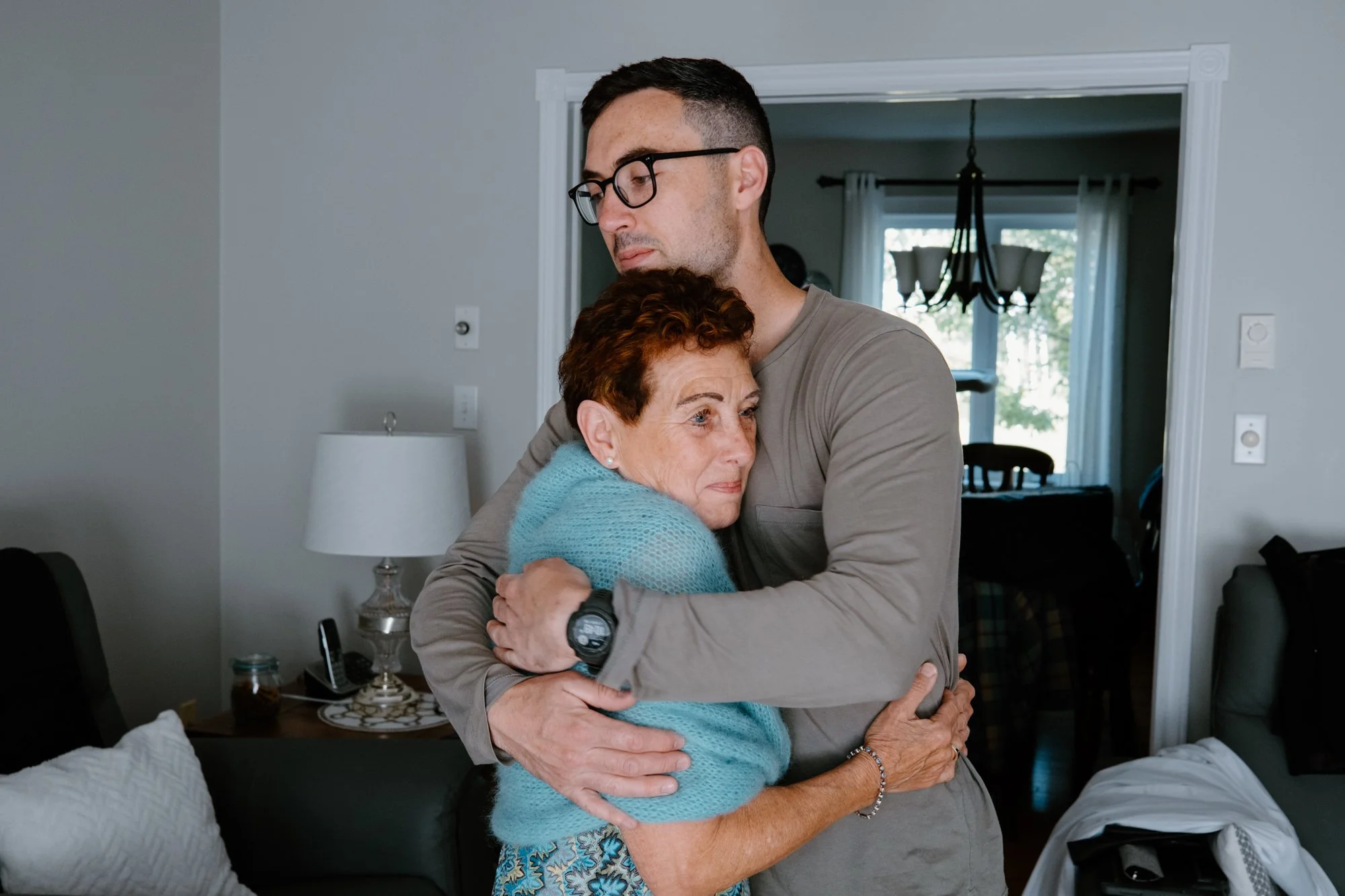 Documentary photo of an emotional moment between a groom and his mother before a destination wedding ceremony