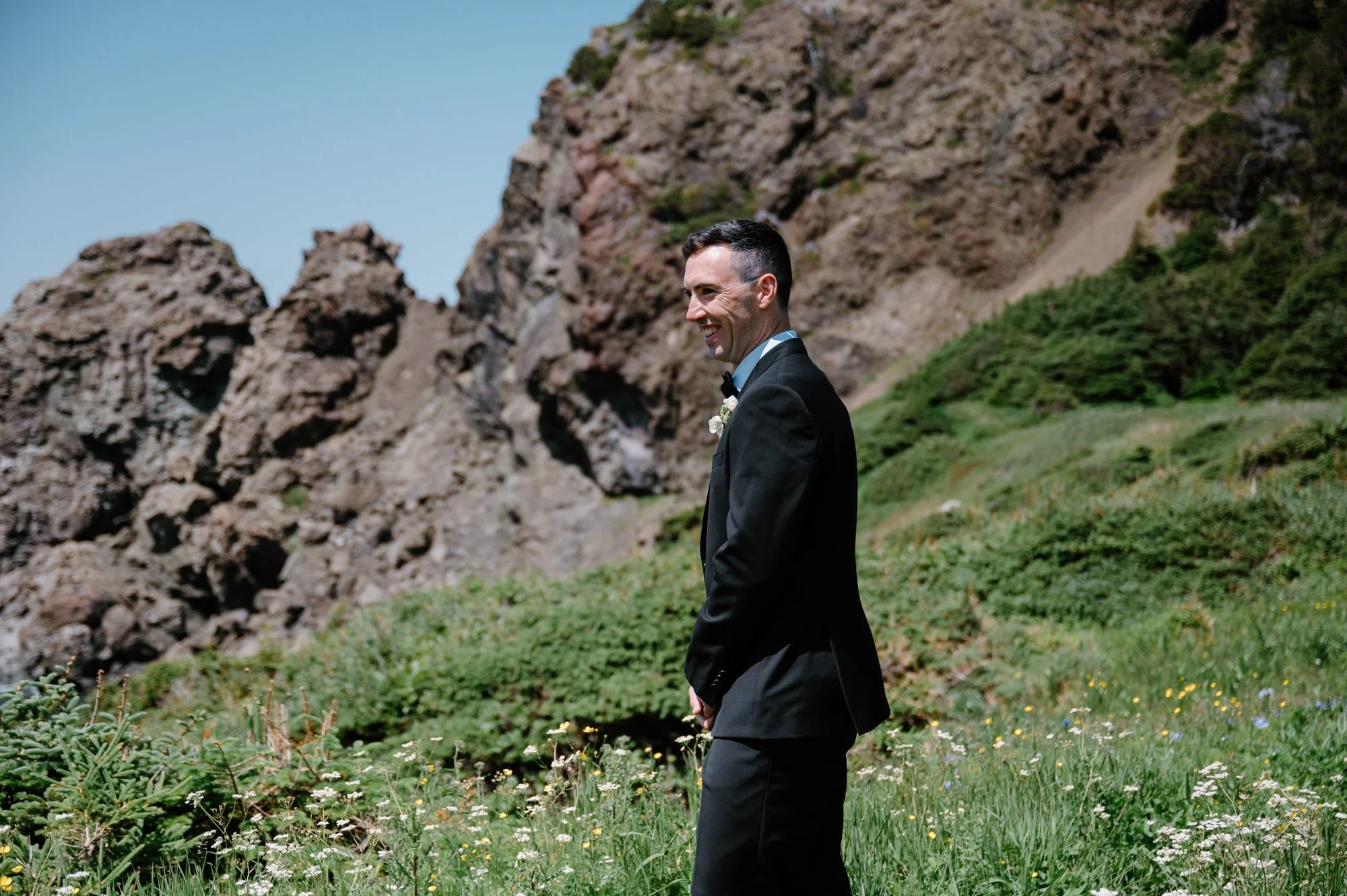 Emotional candid of a groom reacting to seeing his bride for the first time during their first look at a destination wedding
