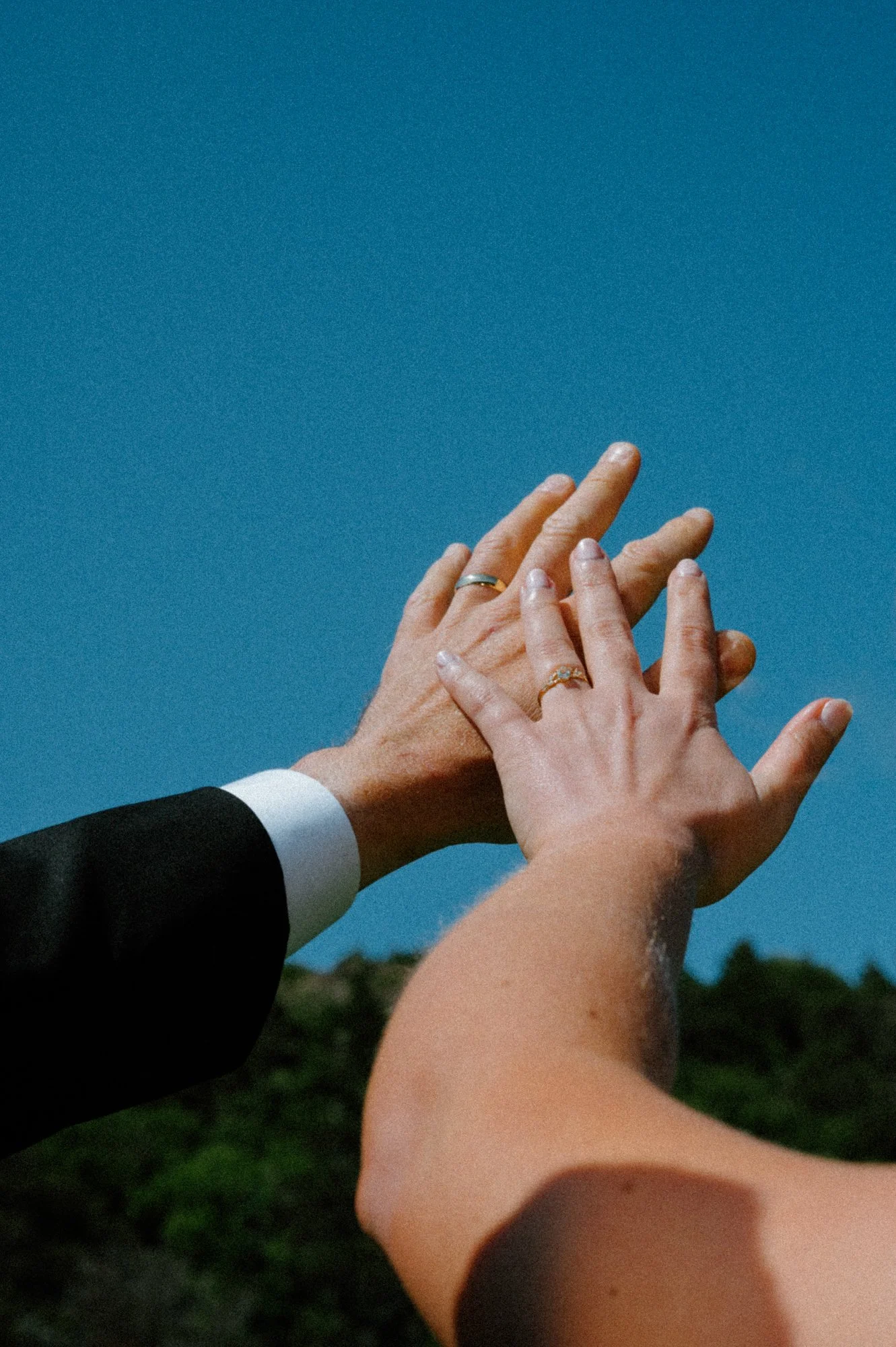 Newly married couple showing off wedding rings