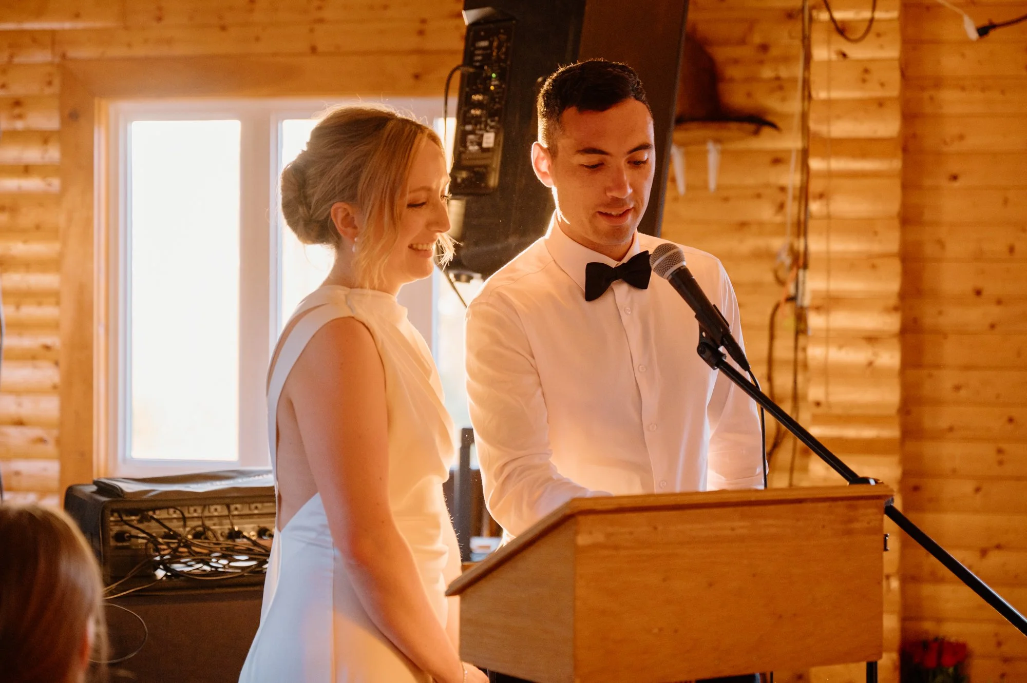 Bride and groom making a speech together during their destination wedding reception