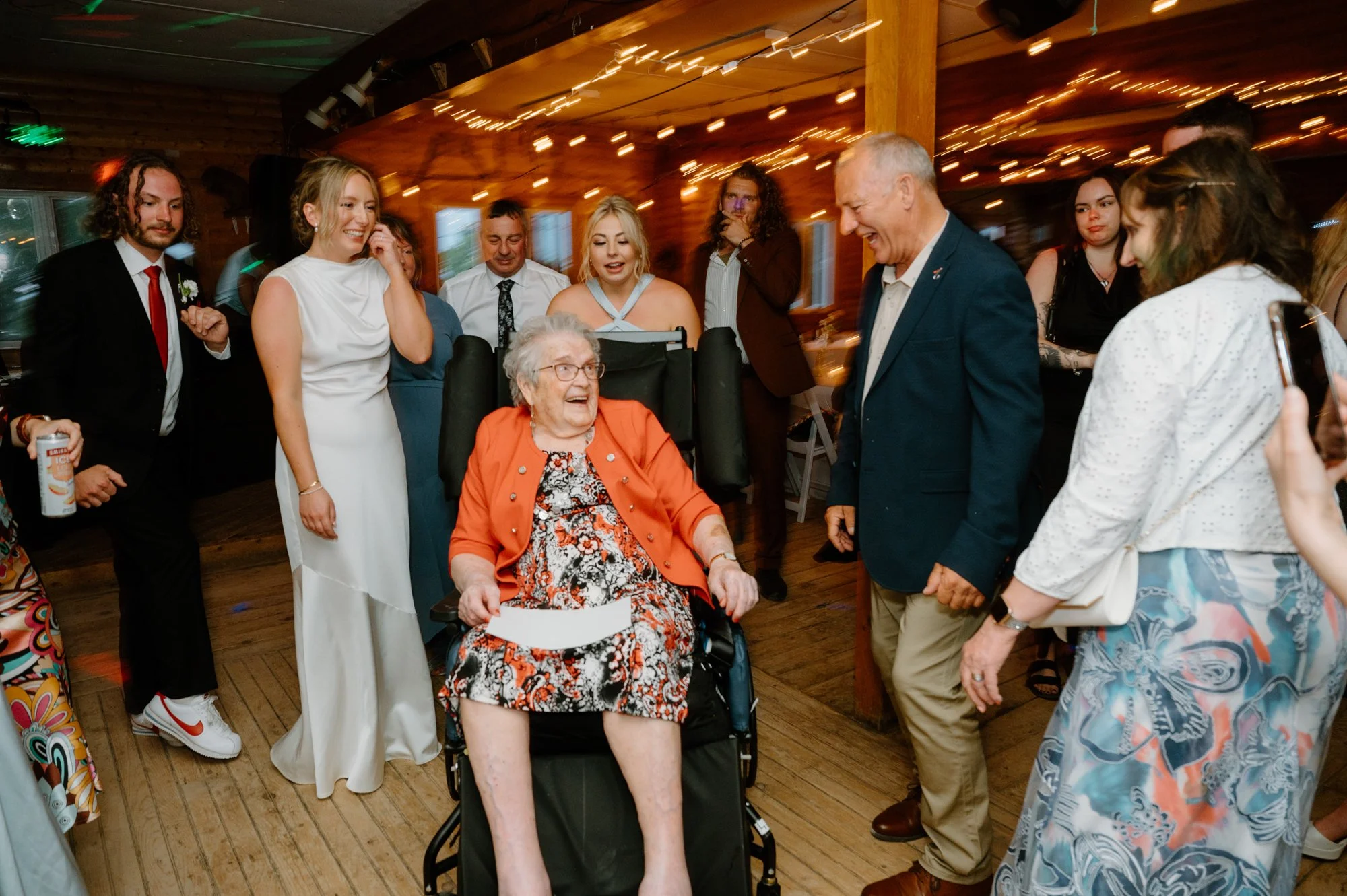 Candid photo of guests dancing, laughing, and having fun at a destination wedding reception
