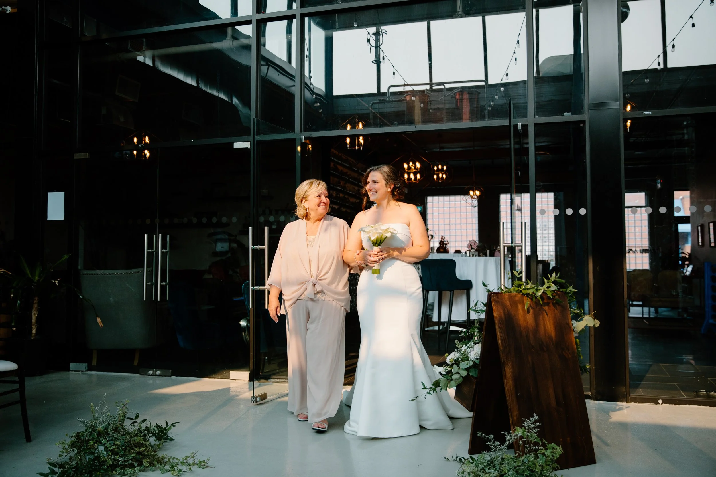 Candid documentary photo of a mother and daughter walking together and smiling on the way to a wedding ceremony in Toronto