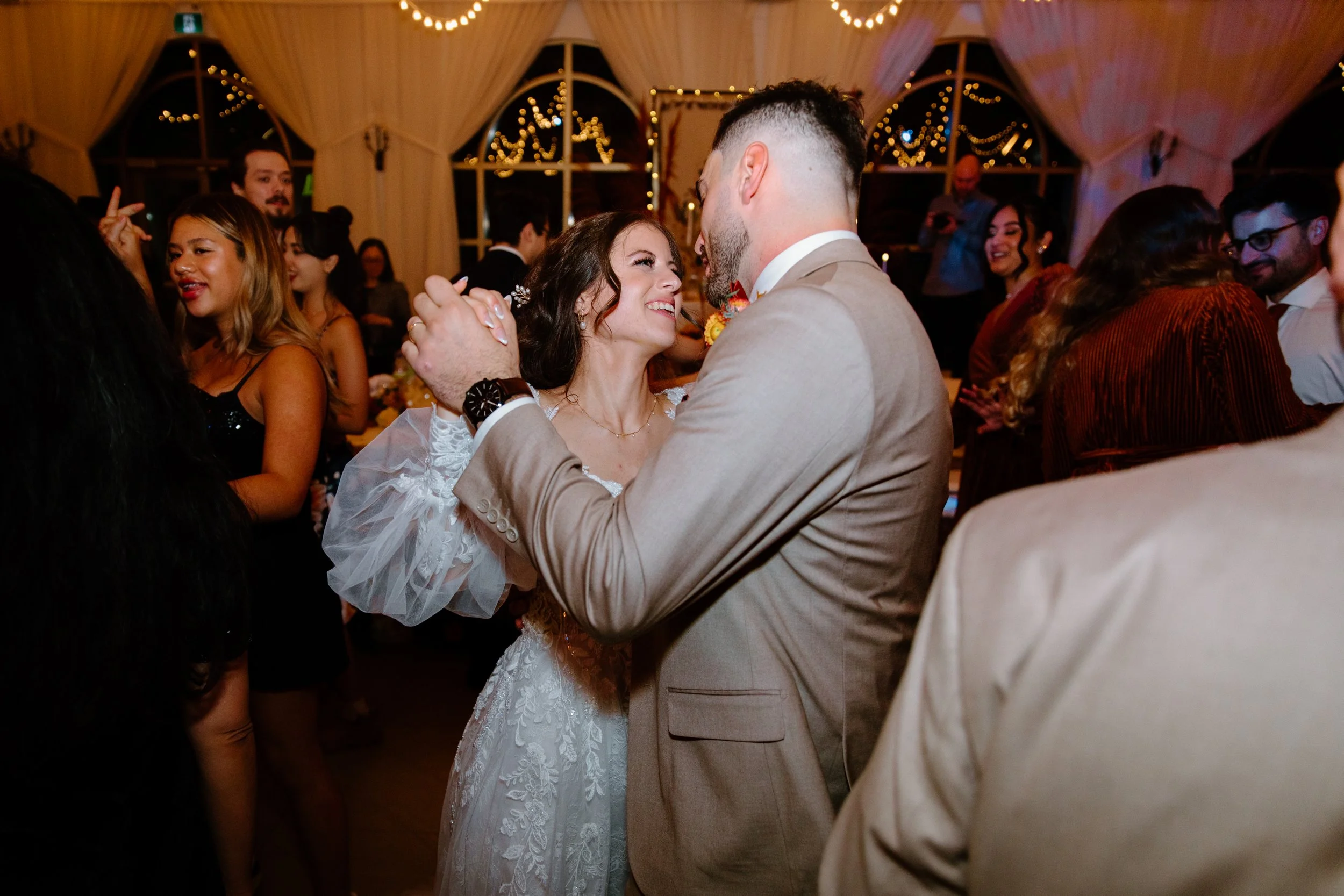Bride and groom dancing in the middle of the dancefloor surrounded by guests at their Caledon wedding reception
