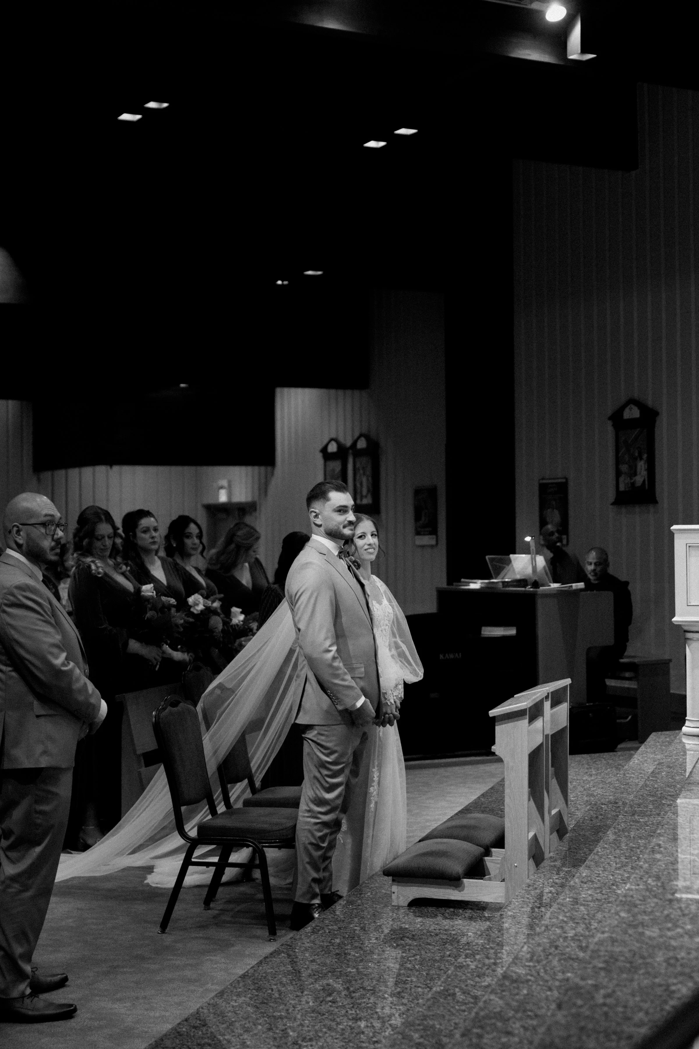 Black and white documentary photo of a bride and groom during their church wedding ceremony in Toronto