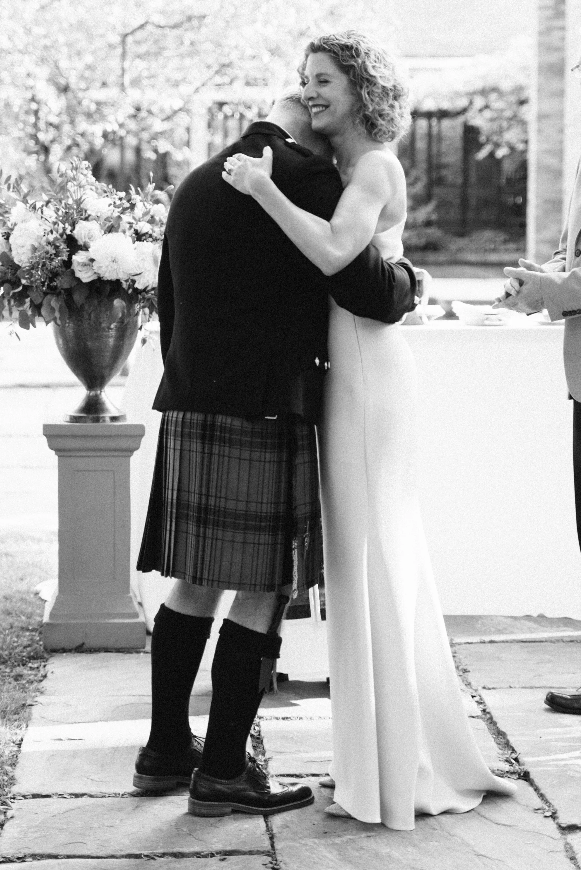Black and white portrait of a bride and groom during their wedding ceremony, photographed at the University of Toronto's Massey College