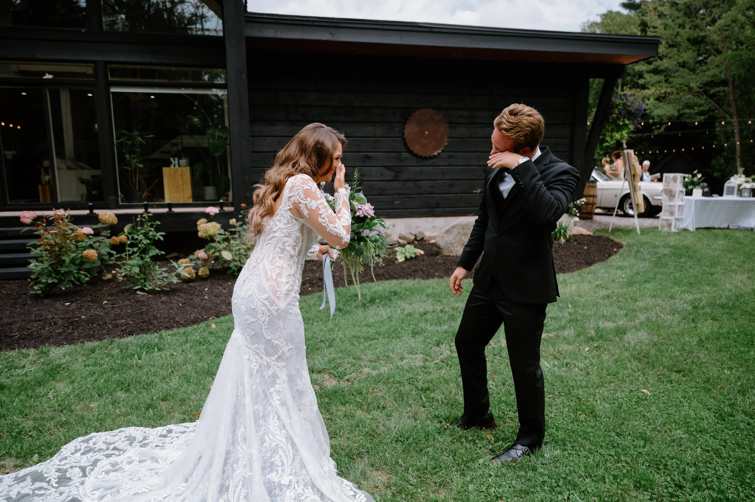An emotional first look between a bride and groom at a luxury cottage wedding in Haliburton, Ontario