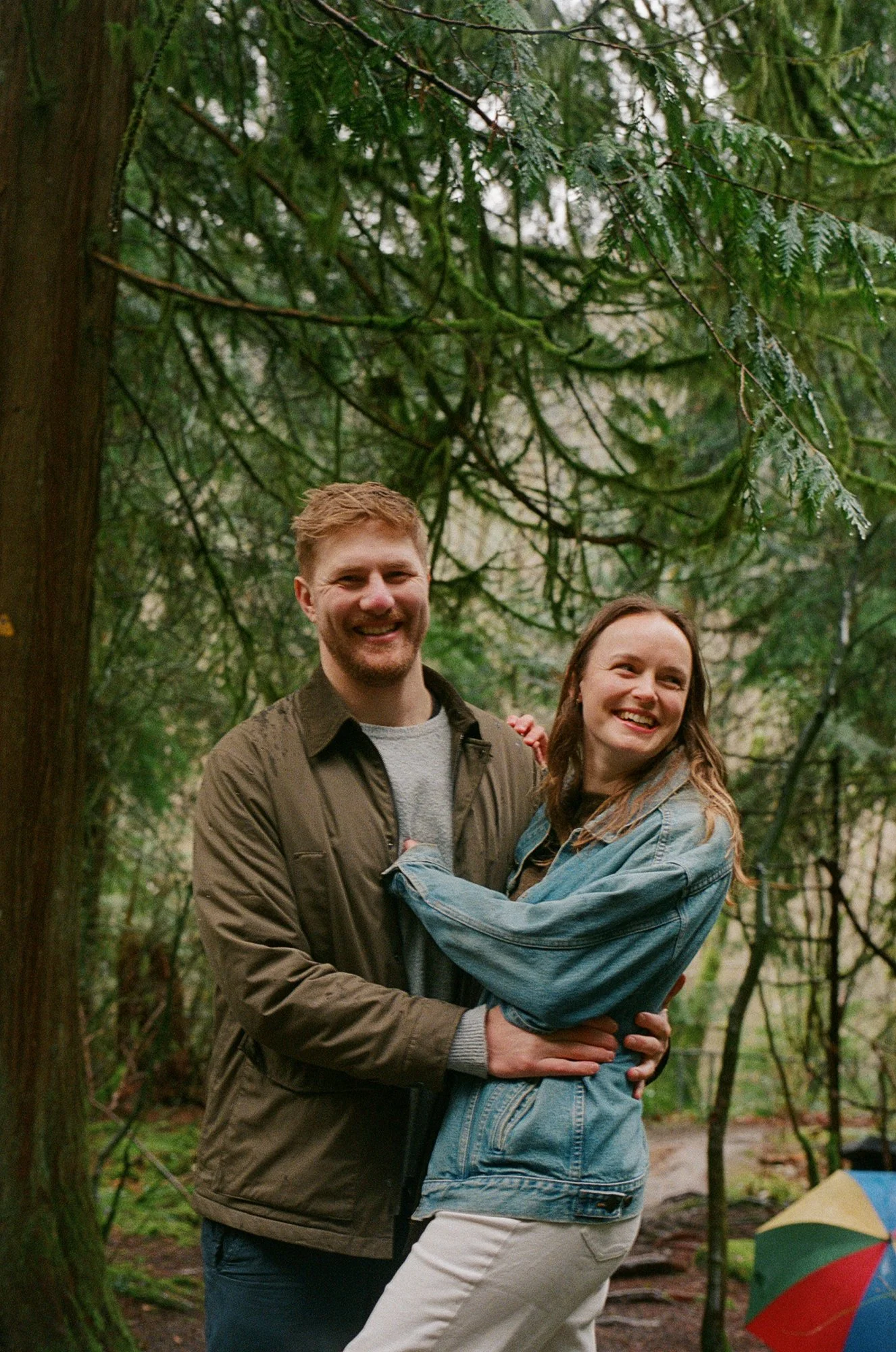 Candid film photograph of a couple on the Lynn Valley trail in North Vancouver, surrounded by Pacific Northwest forest