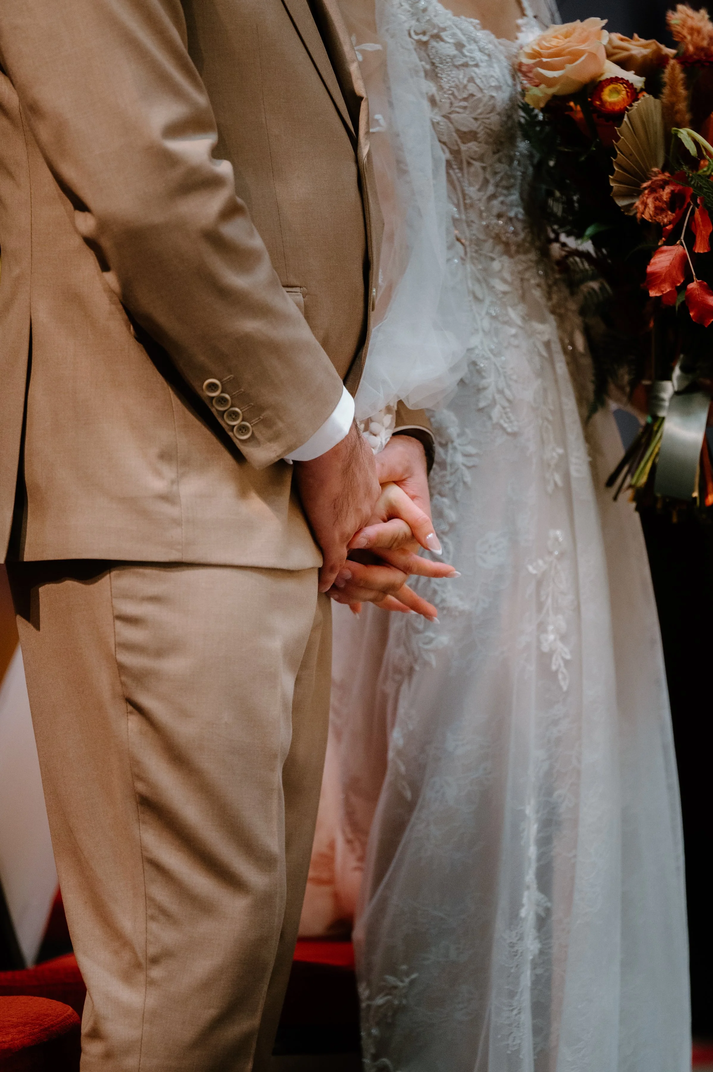 Close up romantic photo of a bride and groom holding hands during their church ceremony in Toronto
