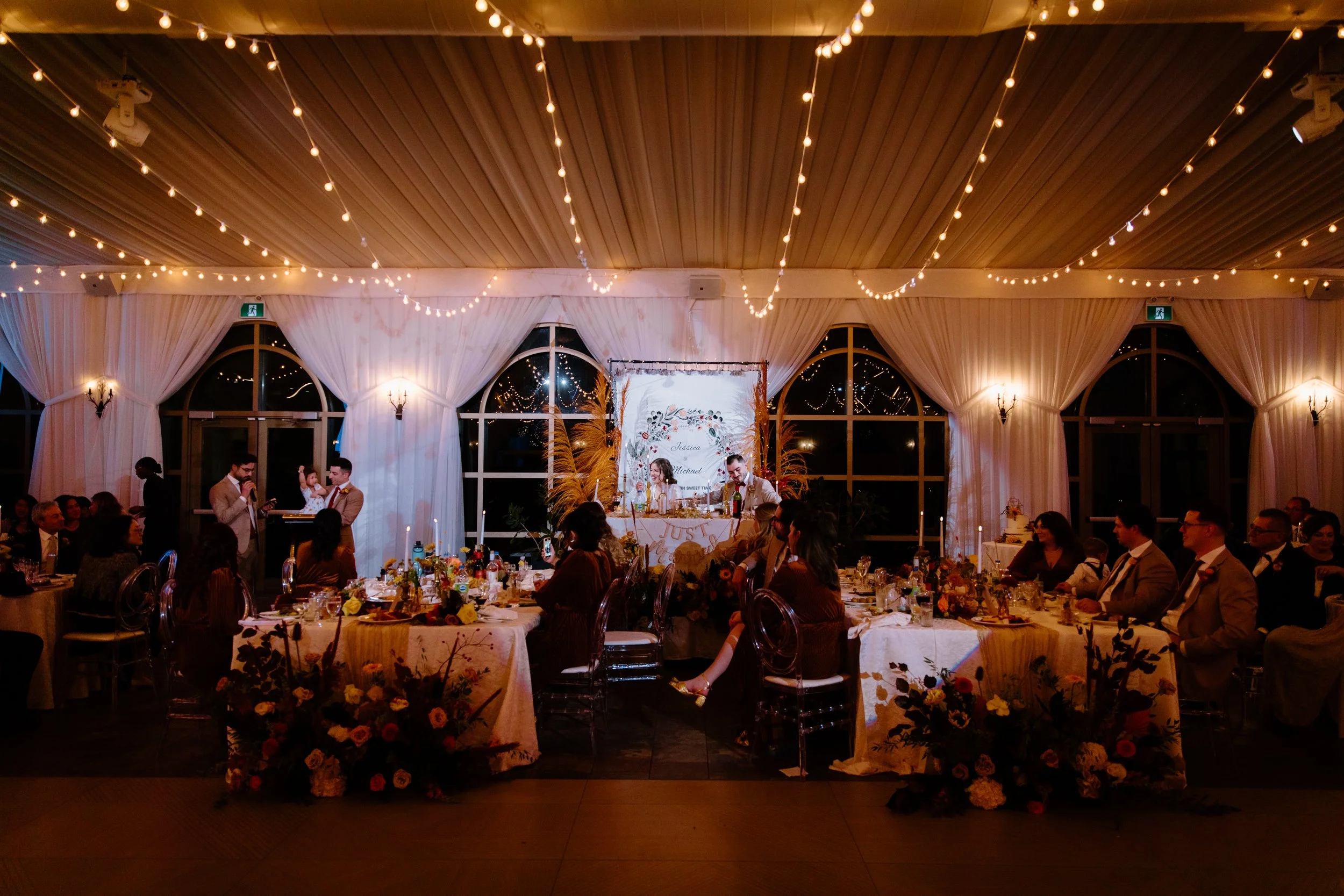 Wide room photo of a wedding party member making a speech during the reception at a Caledon wedding