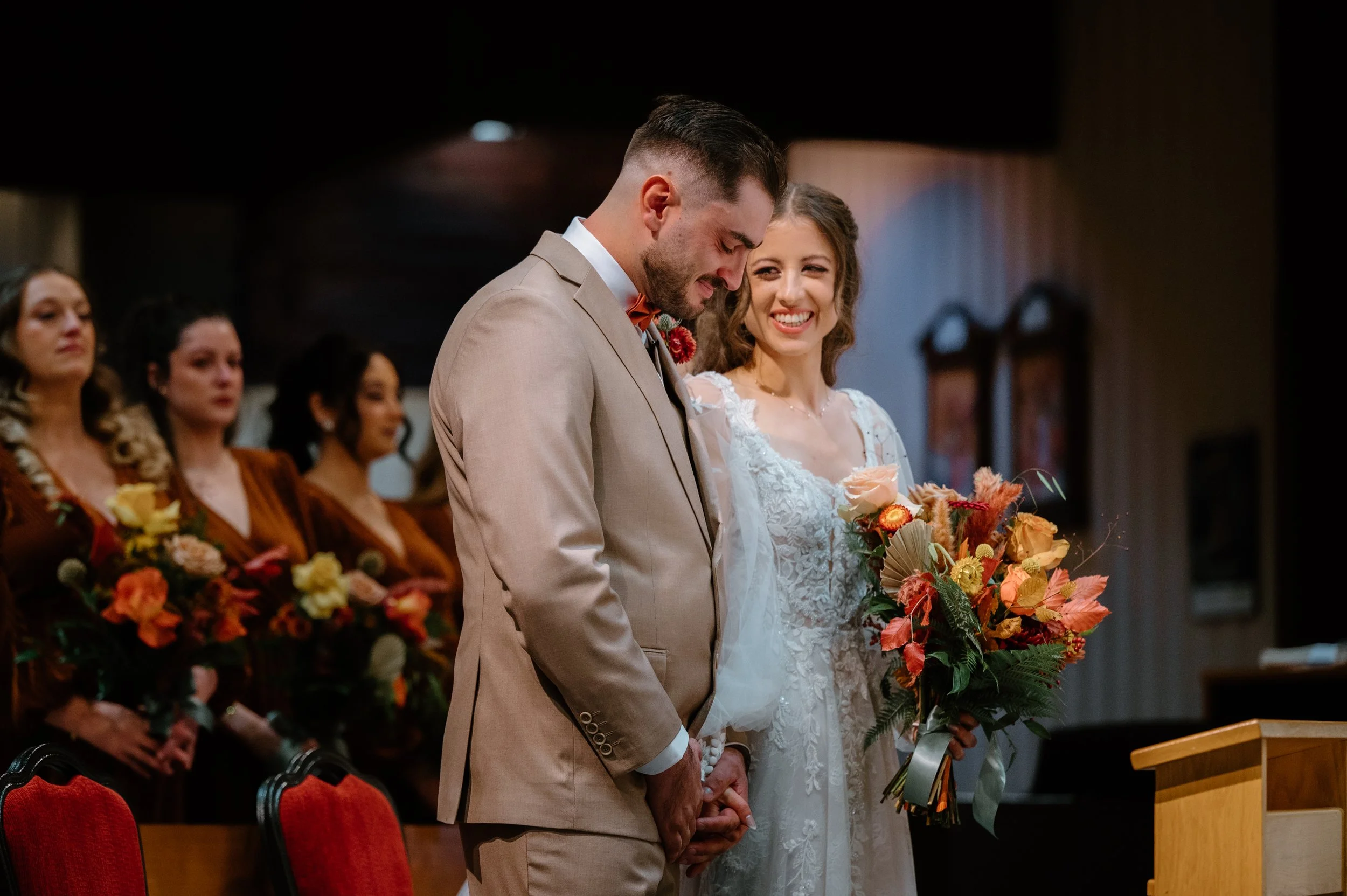 Candid photo of a bride and groom smiling at each other during their church ceremony in Toronto