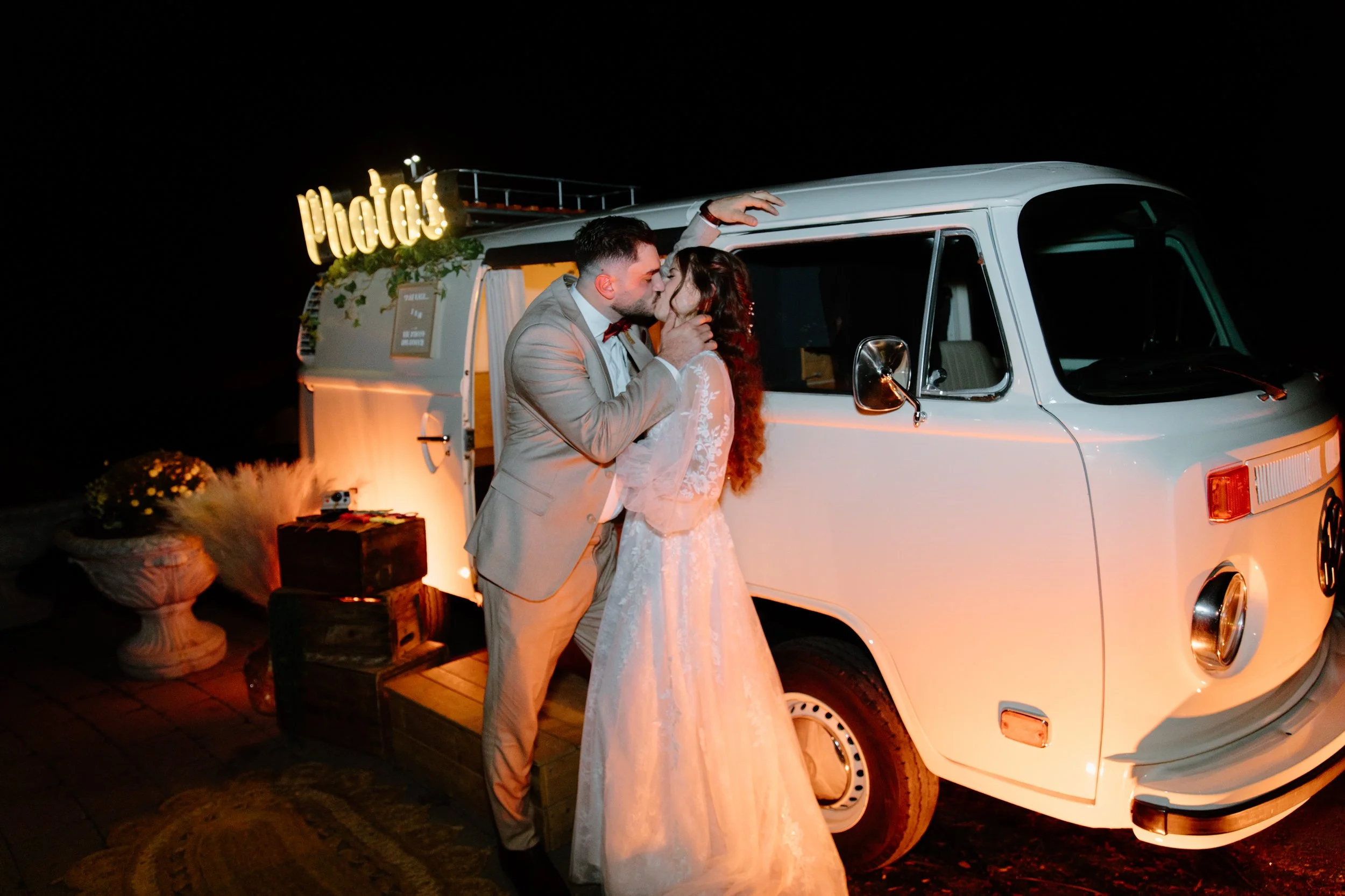 Bride and groom kissing in front of a vintage VW truck photo booth by The Photo Bus Booth at their Caledon wedding