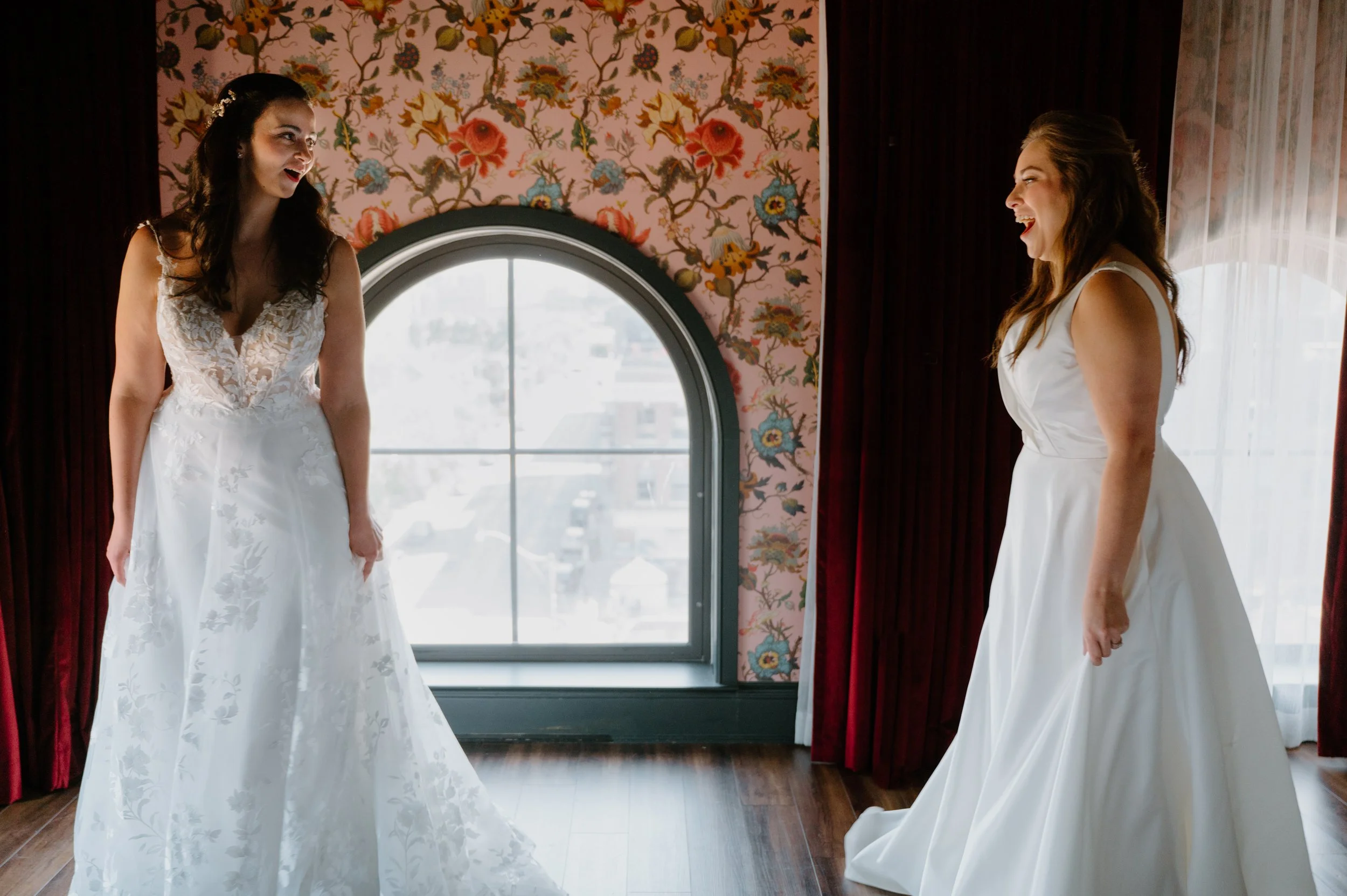 Two brides sharing a moving first look moment at the Broadview Hotel during their Toronto wedding