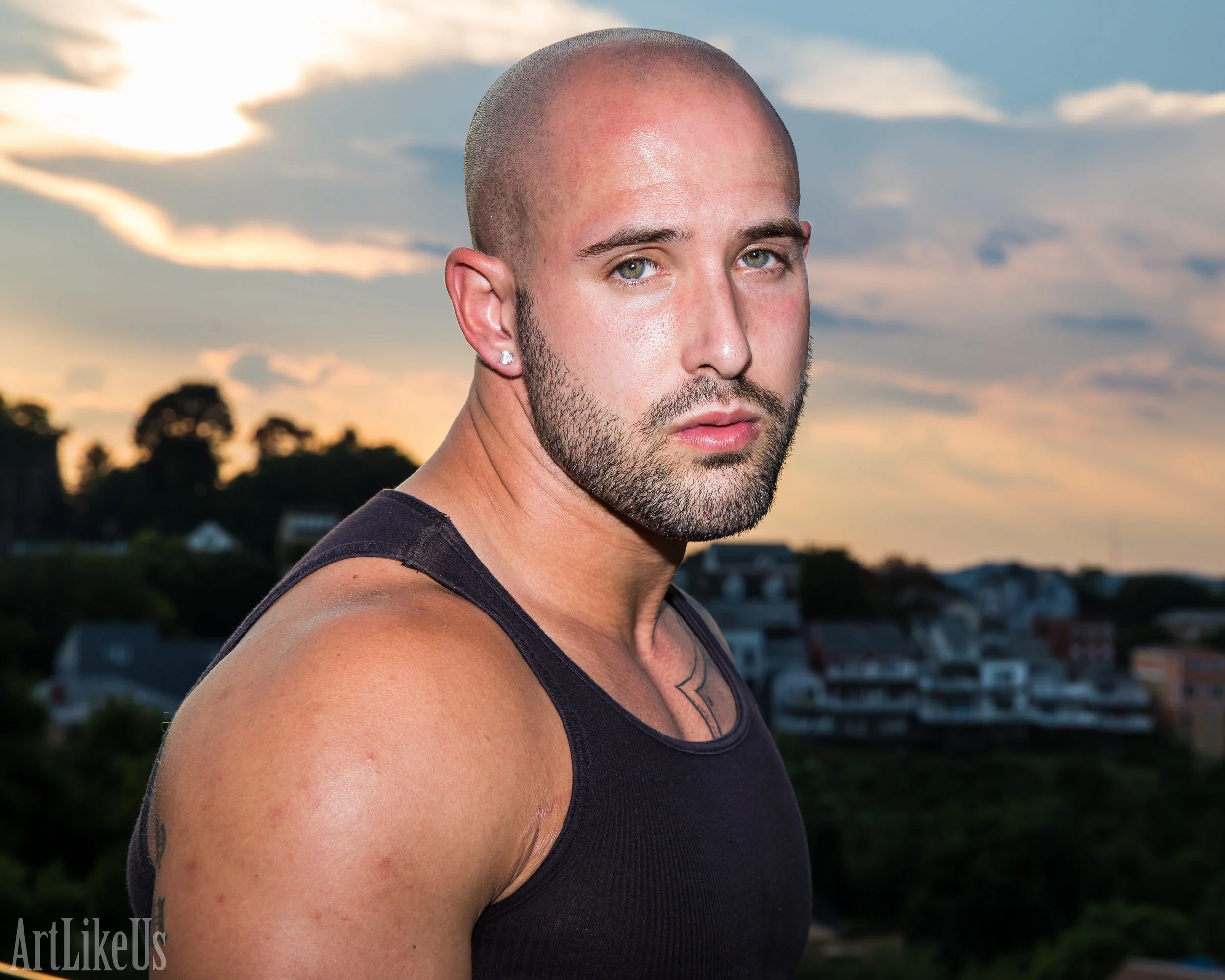 Eddie Holiday posing for a portrait in front of the setting sun.