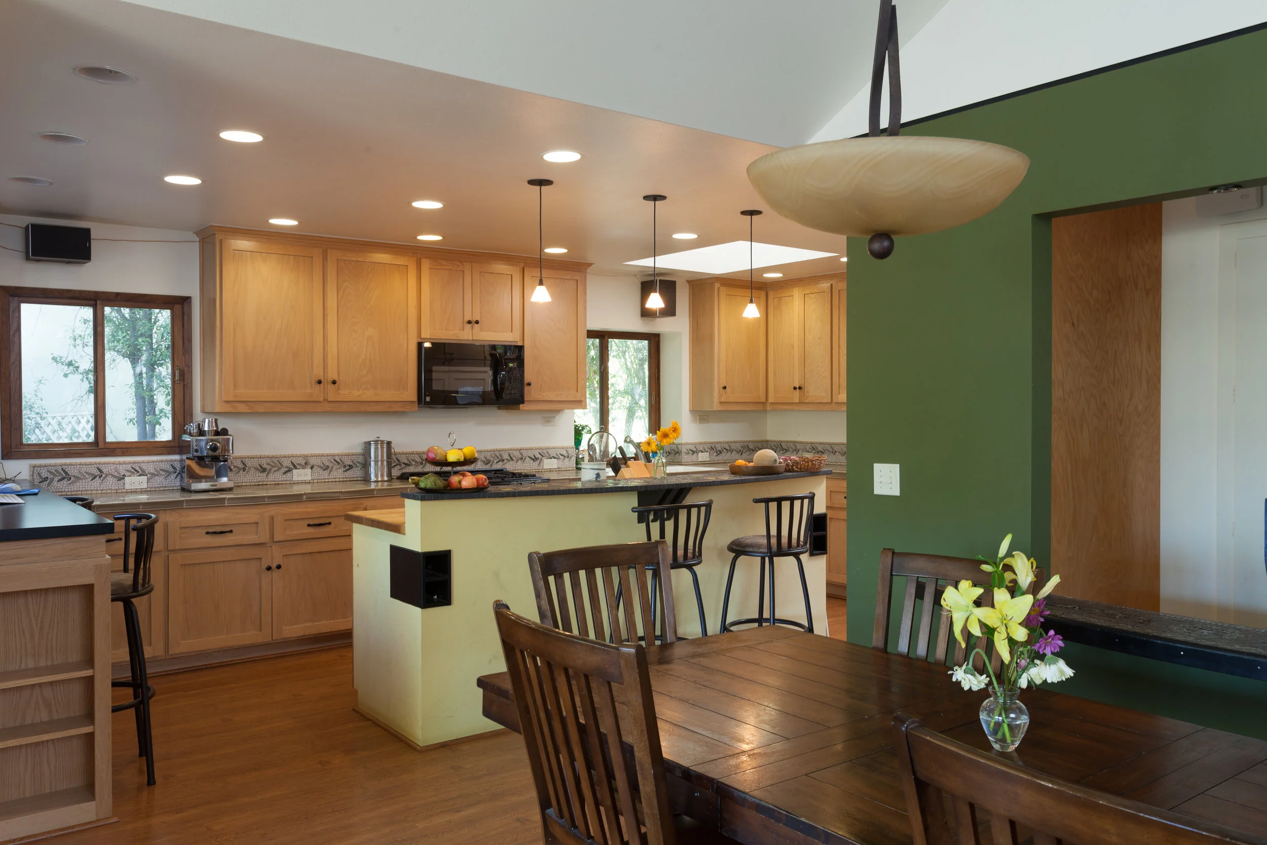 Goleta kitchen/dining room, stained cabinetry, green accent wall