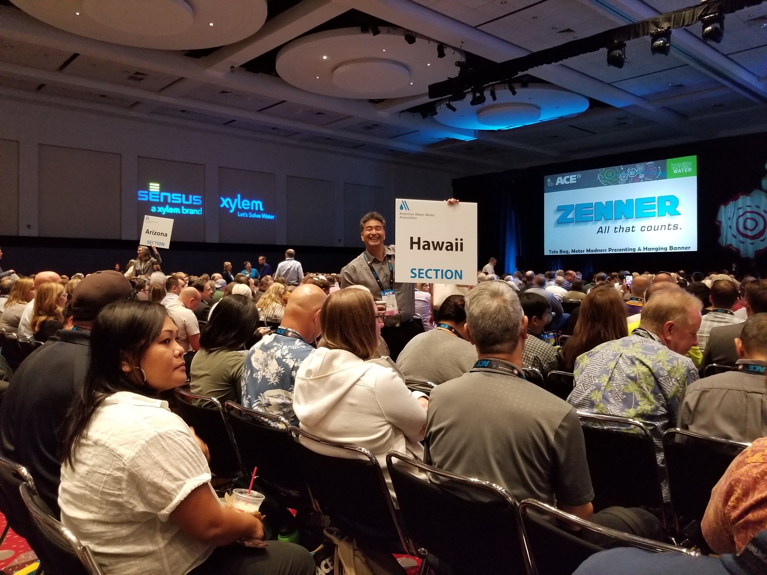 Hawaii Section Chair Kevin Ihu holds the Hawaii Section sign for the ACE19 Opening General Session on 6/10/2019.