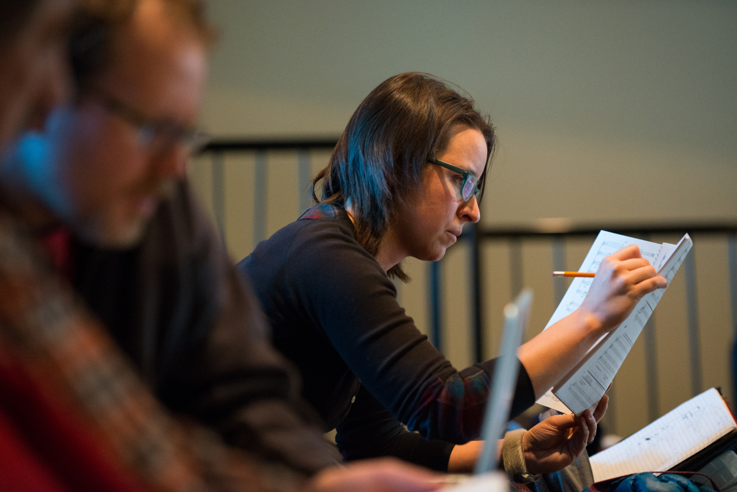 Carmen takes careful notes as she hears her composition come to life during first reading