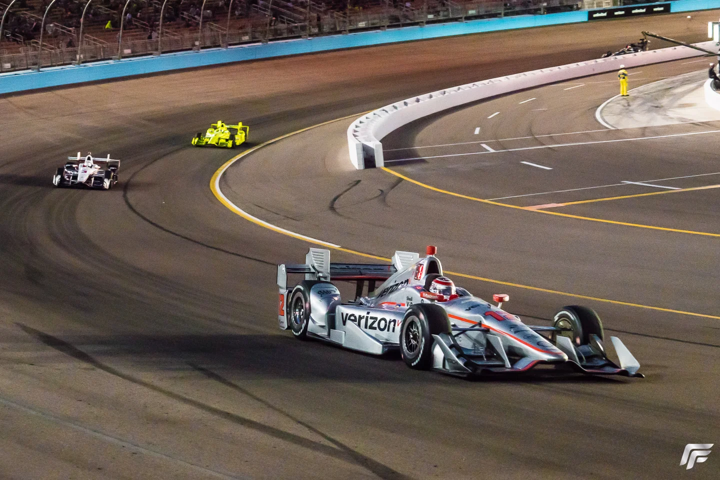 Will Power leads under the lights with Helio Castroneves and Simon Pagenaud pursuing.