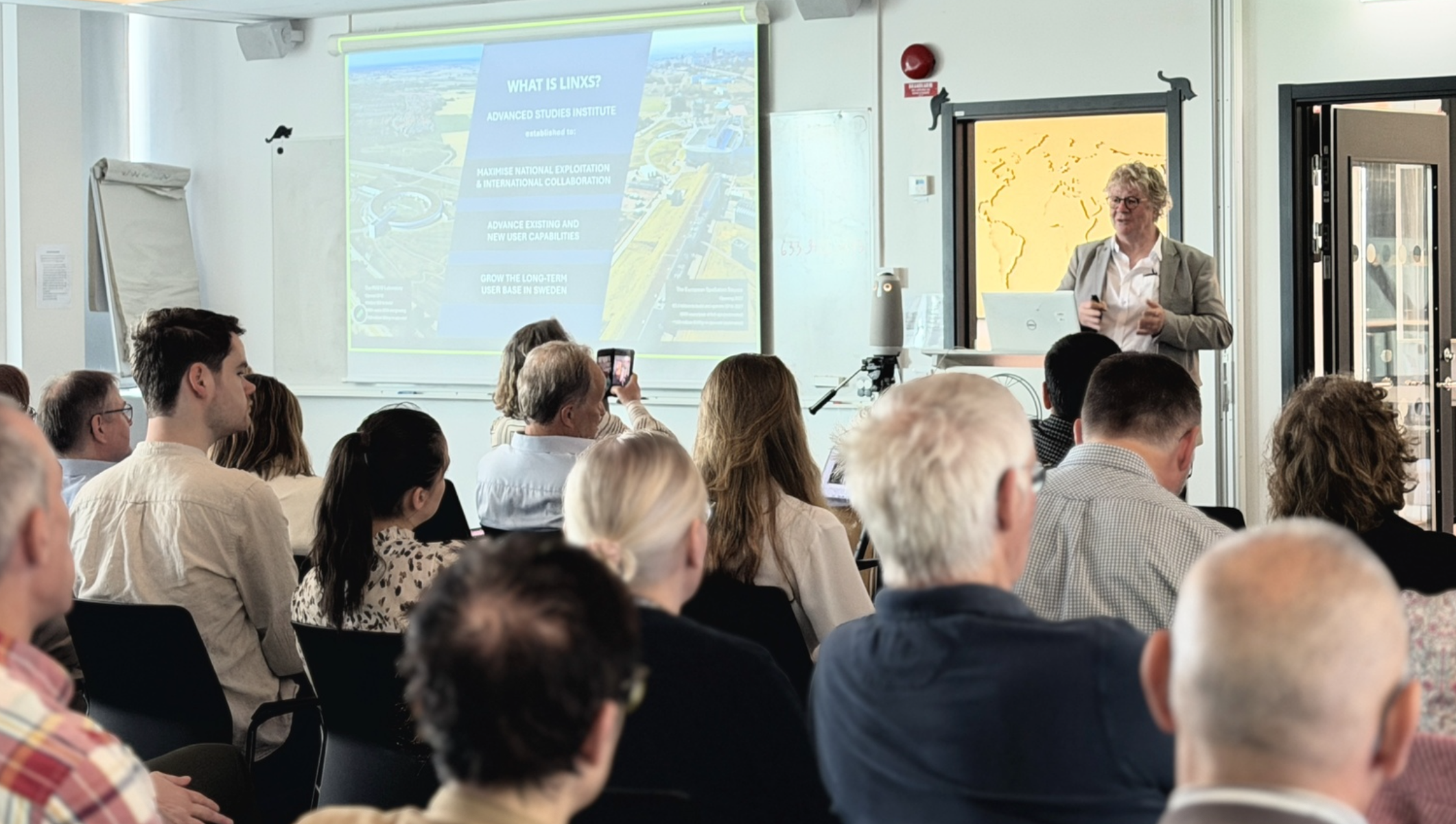 A man, Trevor Forsyth, presenting in a room at LINXS. Photo.