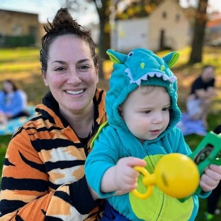 Children enjoying a lively, interactive family music class in the park, engaging in songs, movement, and playful activities suitable for all ages