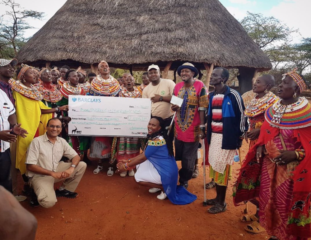 The BeadWORKS artisans of Kalama Conservancy present their conservation contribution check for 2018 to their chairperson during a ceremony in late May.