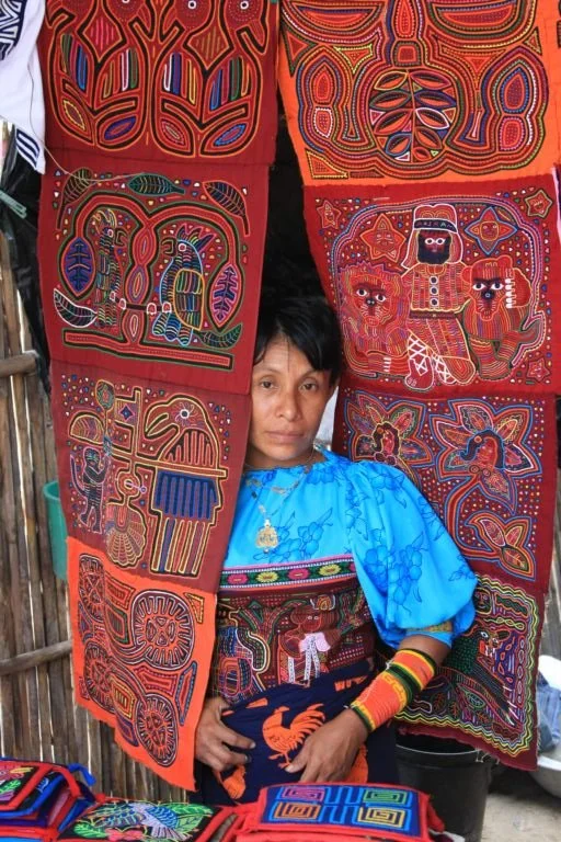 An artist from the Kuna tribe displays her handmade molas in the San Blas Islands of Panama.