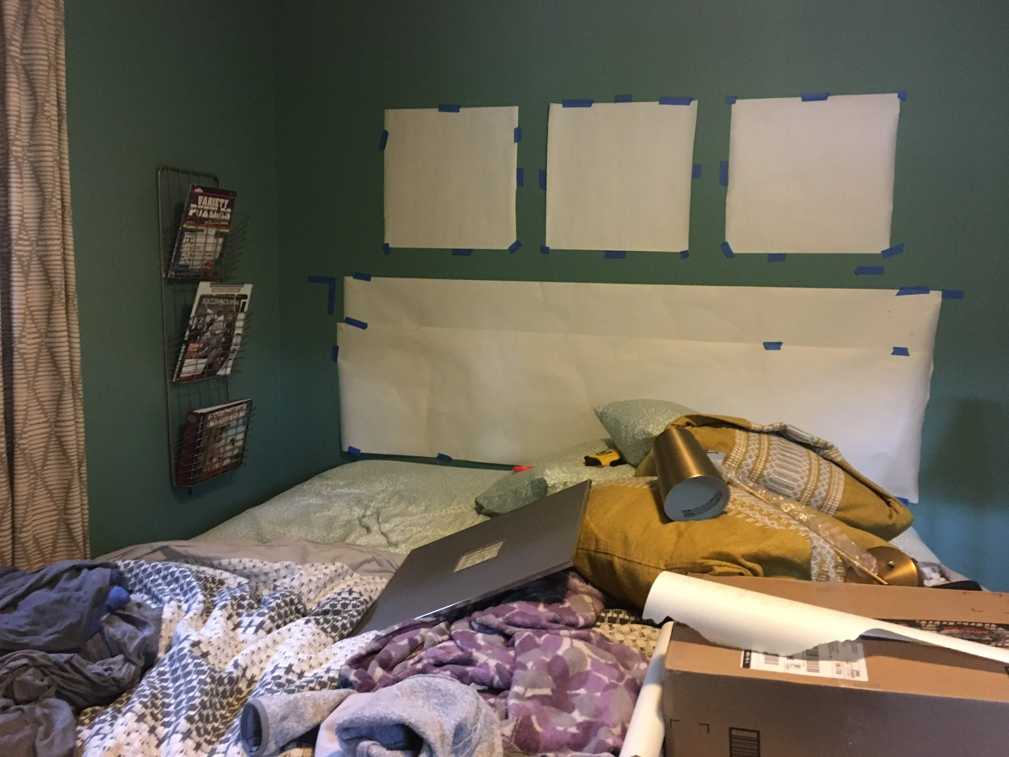 Planning the location of the headboard and frames by measuring and posting paper up on the wall. Just a glimpse of what my bedroom will look like. 