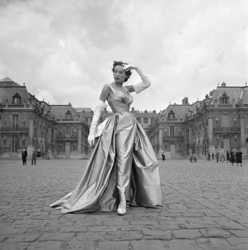 A model wears Dior in Paris, 1951. Photograph by Willy Maywald. 