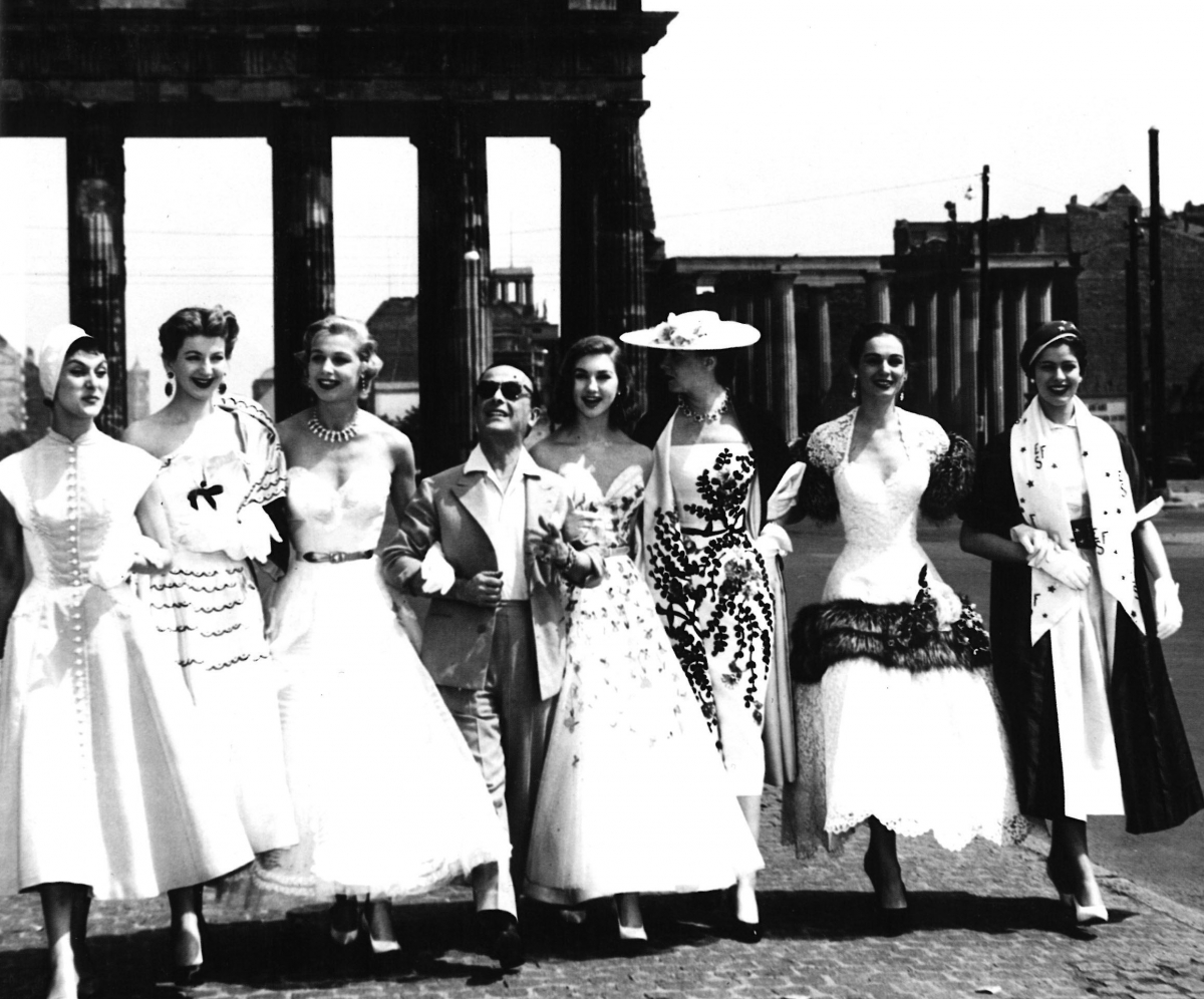 Pictured with models in his designs, 1953