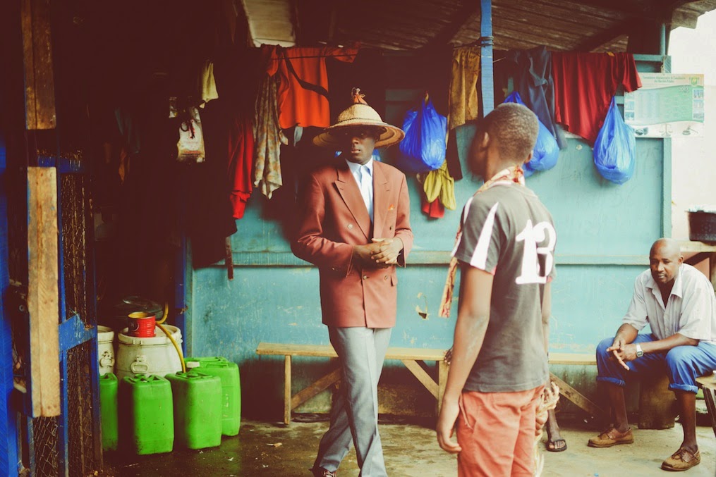 A double-breasted blazer accessorized with a hat. 
