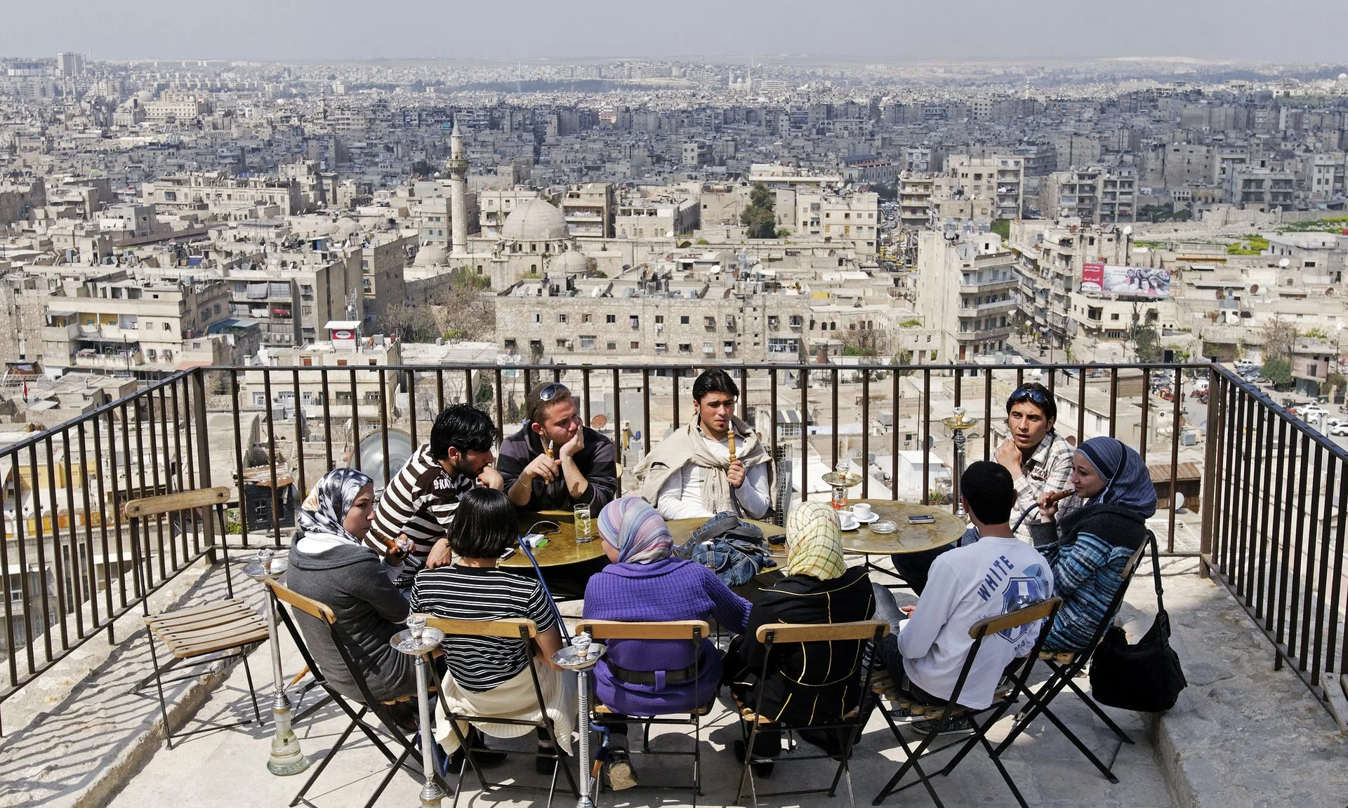 Aleppo, Syria in 2009. "Young people socialising (sic) on the hill of the Citadel of Aleppo, two years before the start of the Arab spring protests that led the civil war." via The Guardian Photograph: imageBROKER/REX/Shutterstock