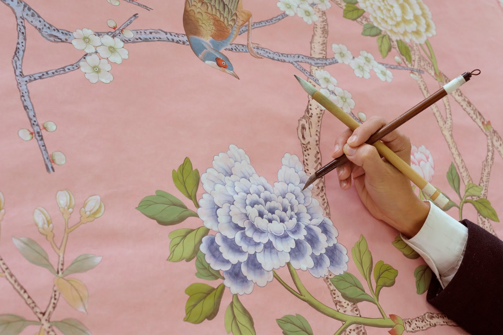 An artisan hand-painting a de Gournay panel