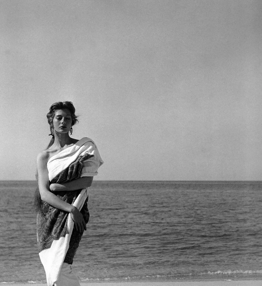 Fiona Campbell-Walter wearing a Givenchy towel in Corsica, 1954. Photo by Georges Dambier.