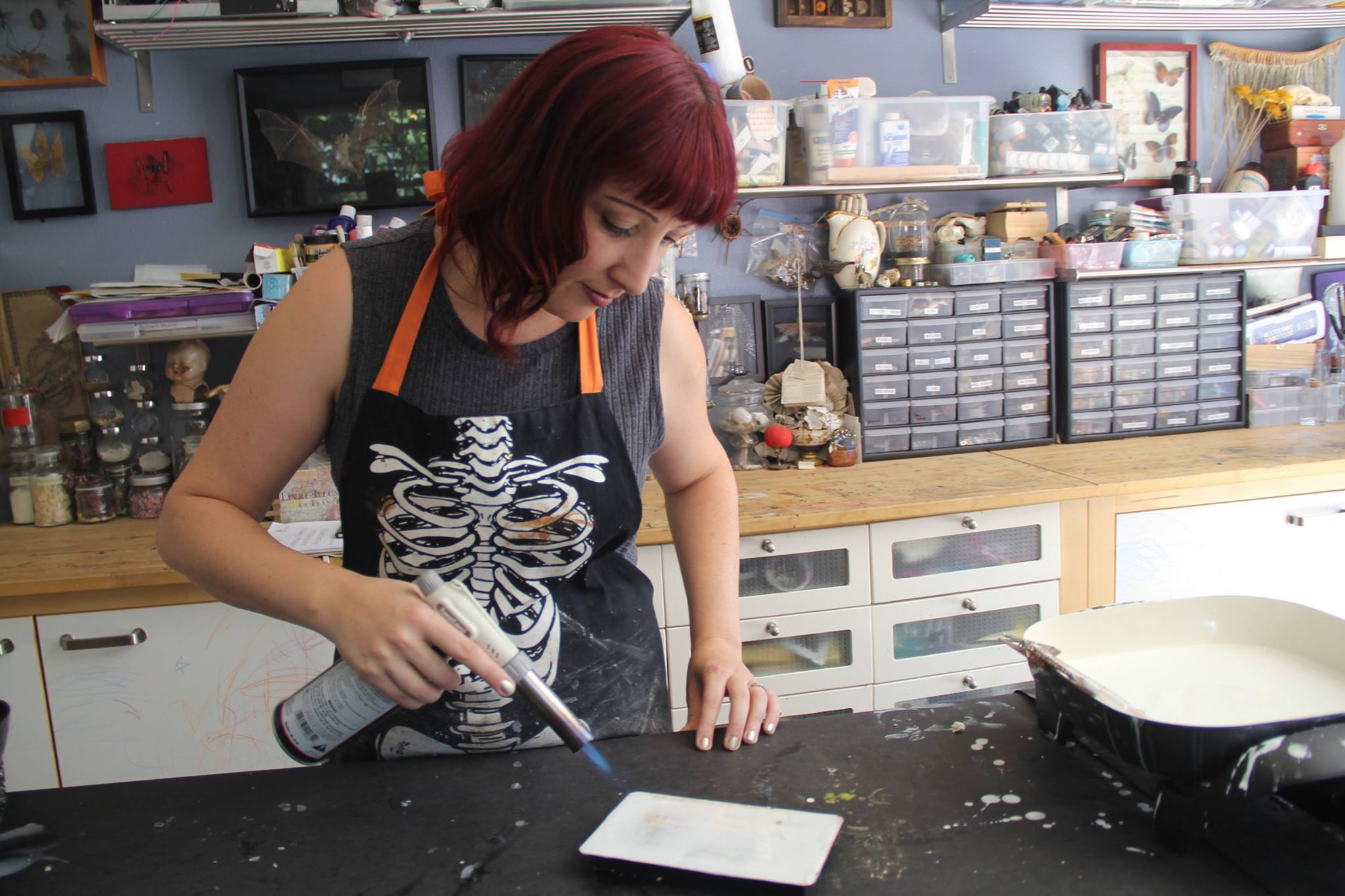 Shannon Amidon using a torch to fuse and encaustic piece