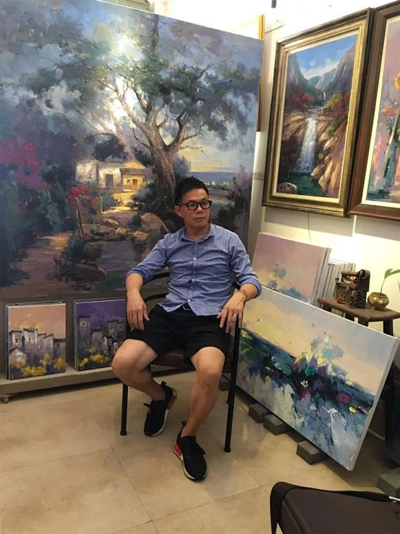 Chinese artist Jingshen You posing with his artwork