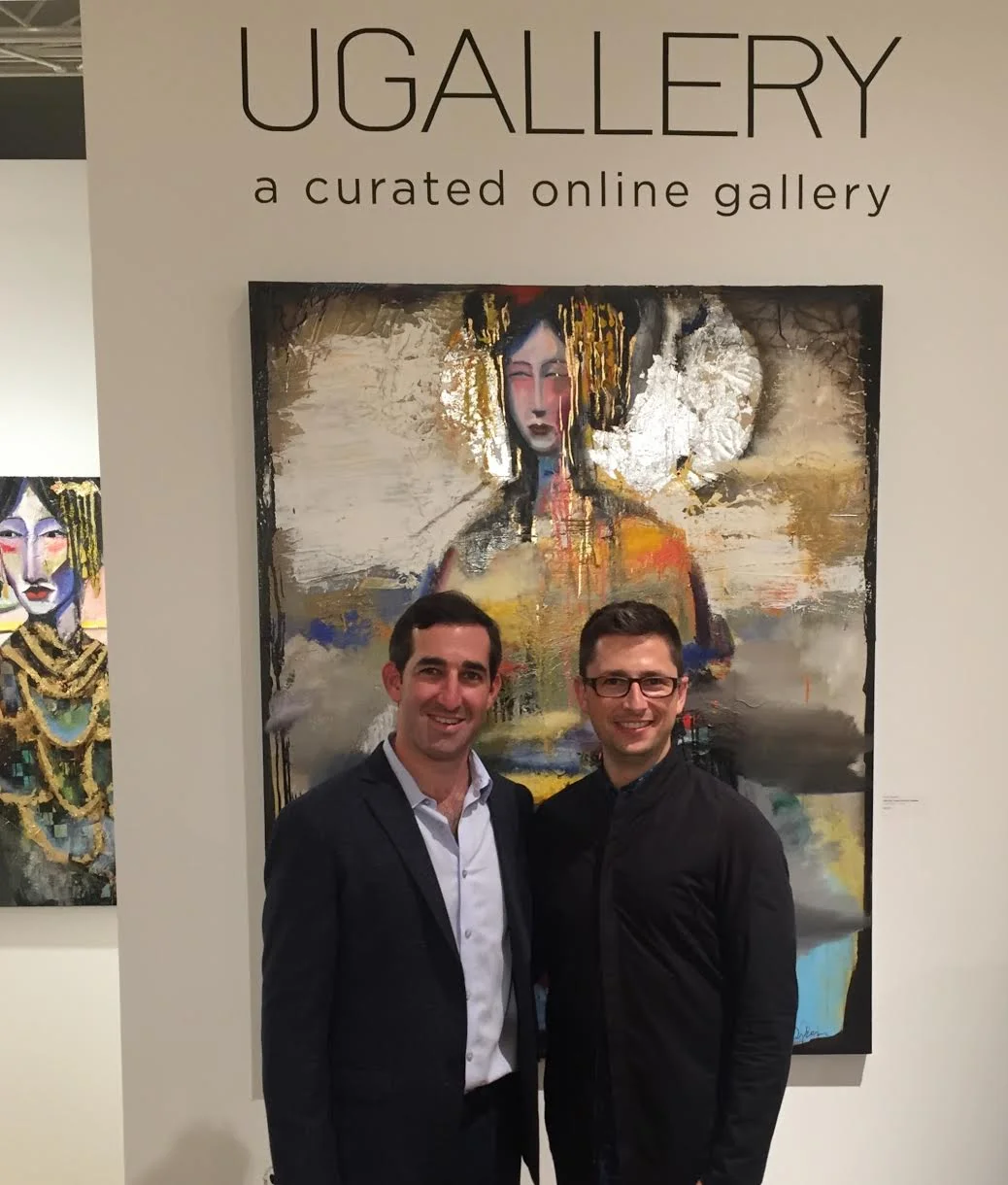 UGallery co-founders Stephen Tanenbaum and Alex Farkas in front of artwork by Scott Dykema