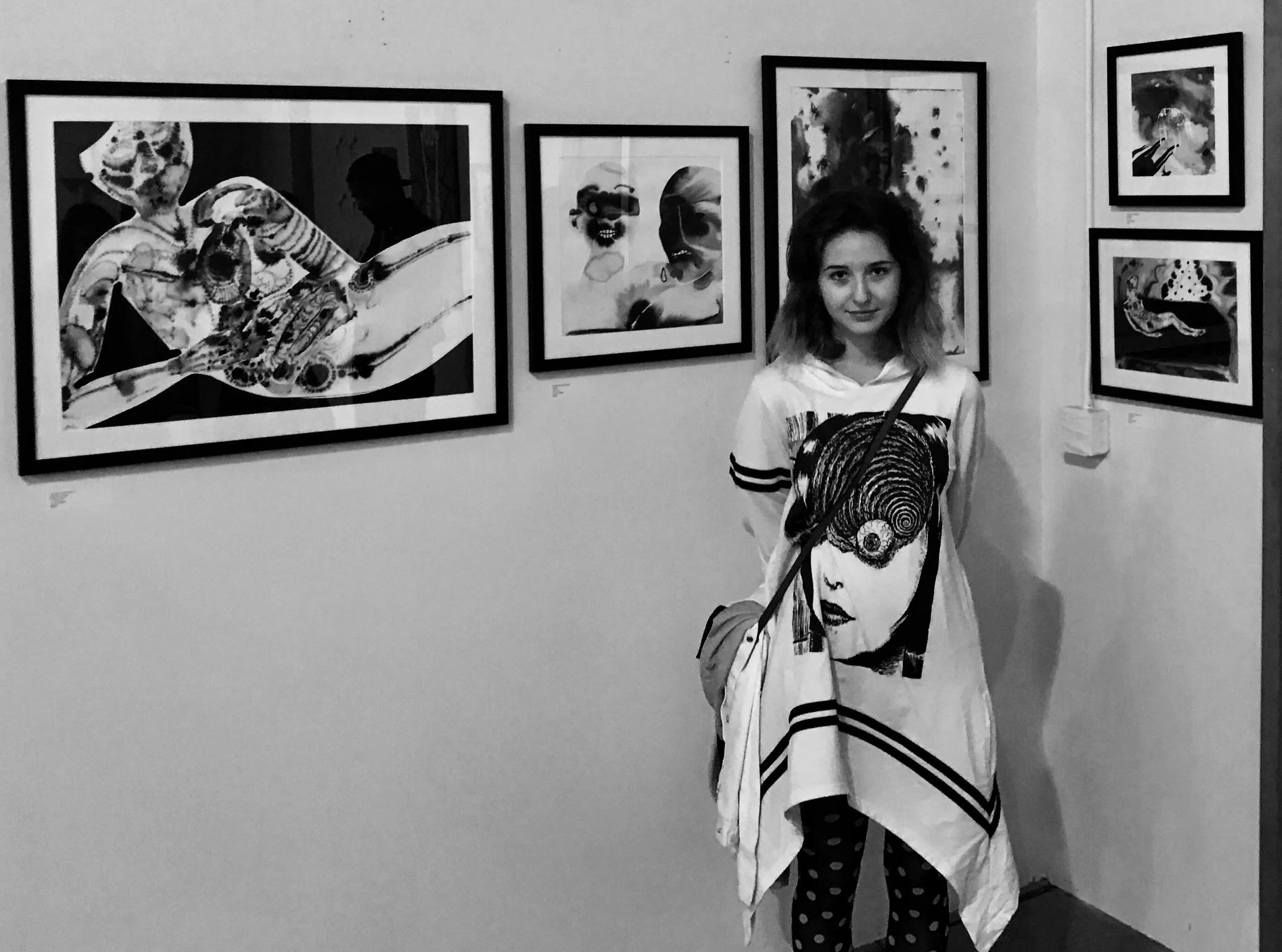Annalise LaFlamme photographed in front of her artwork.