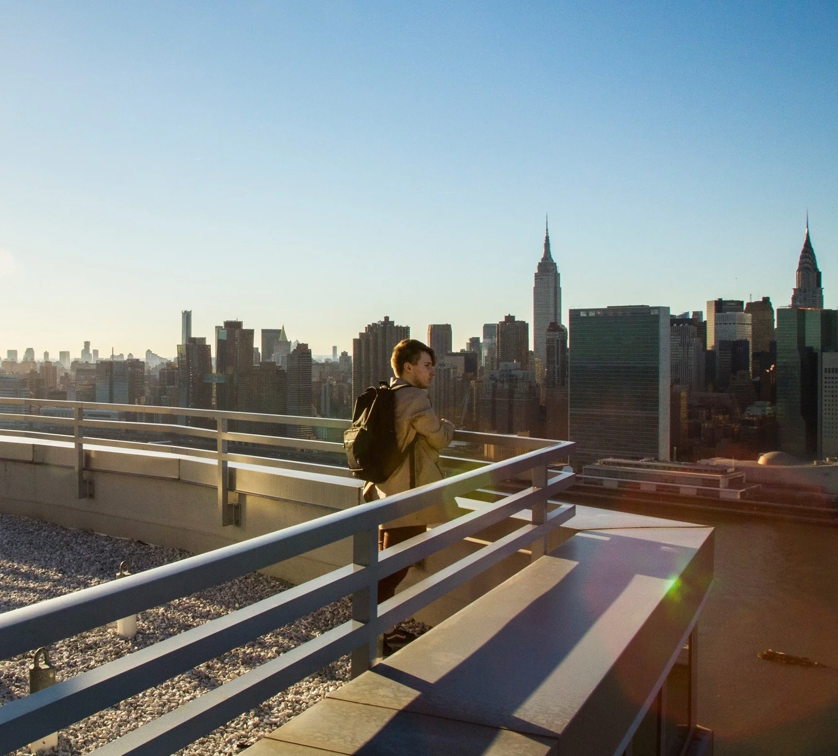 Anthony Sokolov on top of his building looking onto the Manhattan skyline