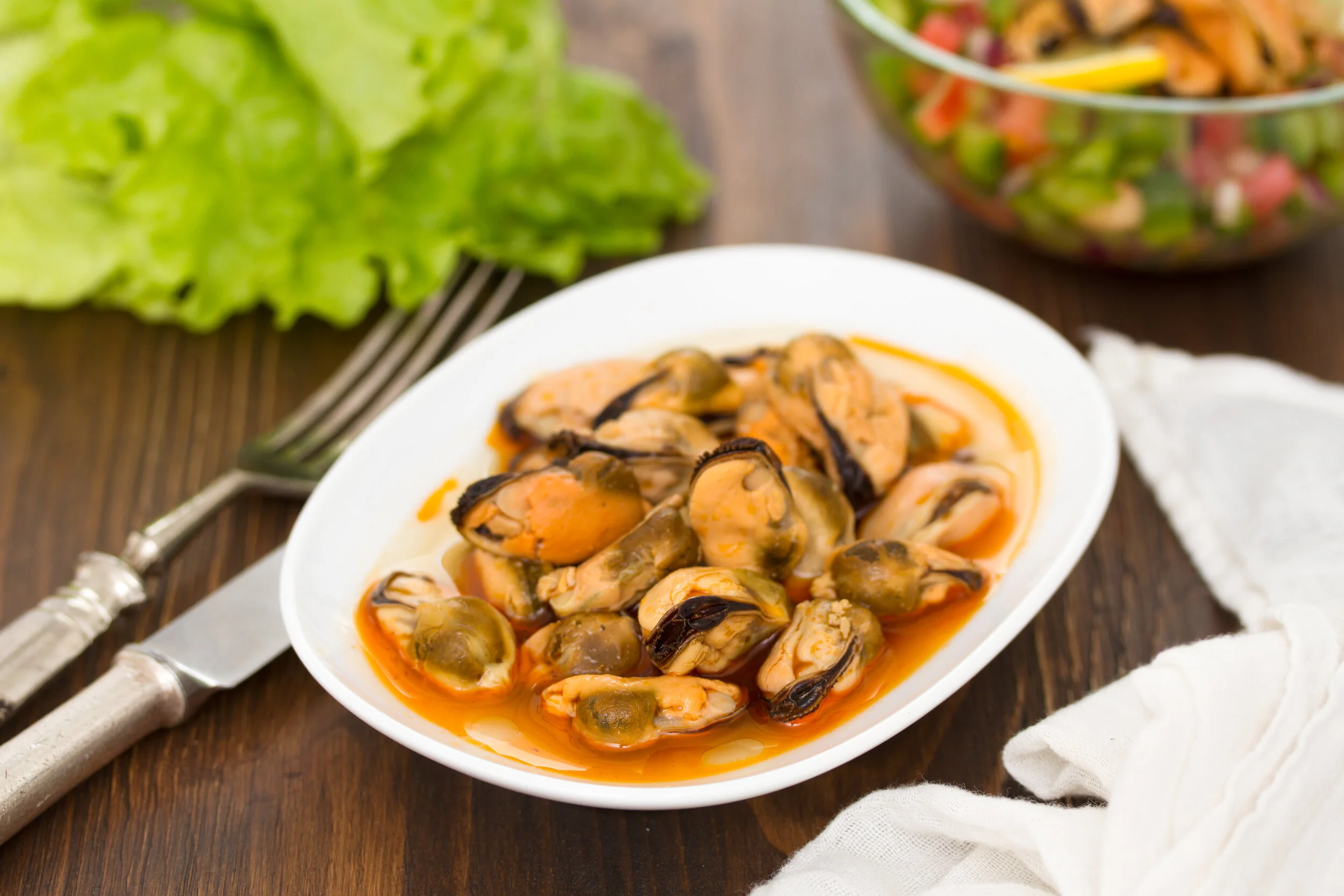 Mussels In Sauce On White Dish On Wooden Background