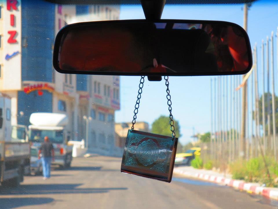  A Qur'an hangs from the rearview mirror of a car in Ramallah, West Bank. 