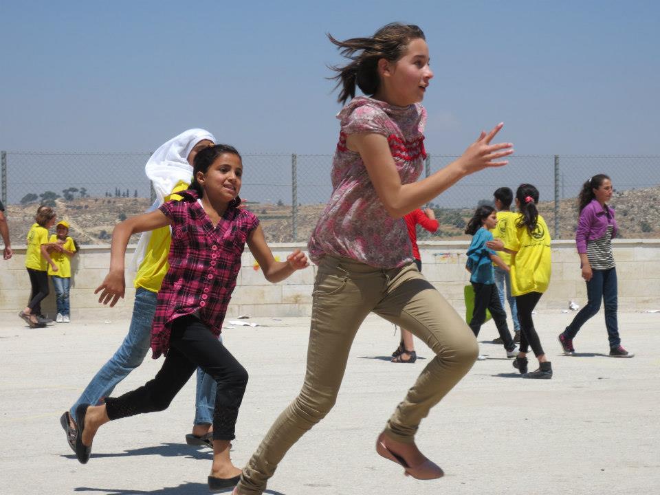   Children pay tag during recess time at a summer camp in al-Khalil, West Bank. June, 2012.  