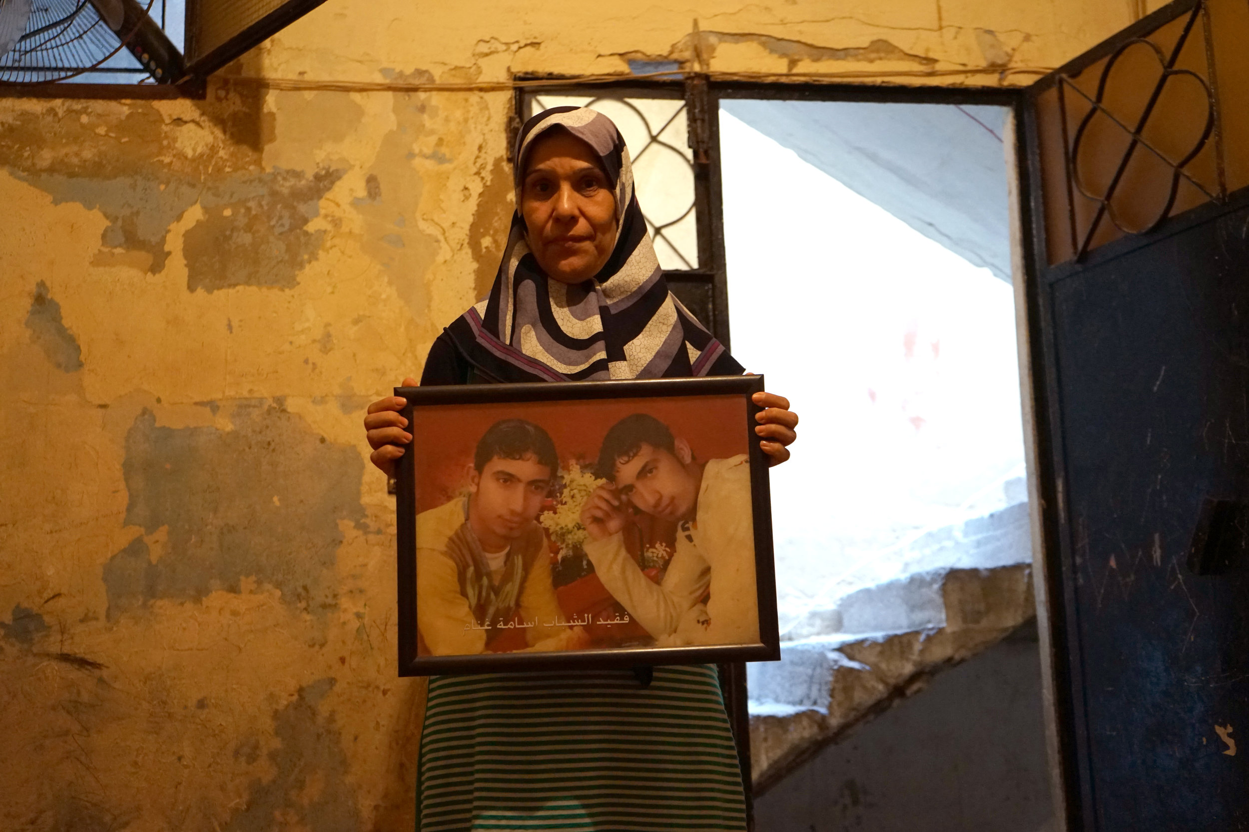  Hana Leila, Ghanam's wife, holds a picture of their deceased son on August 17, 2016. 