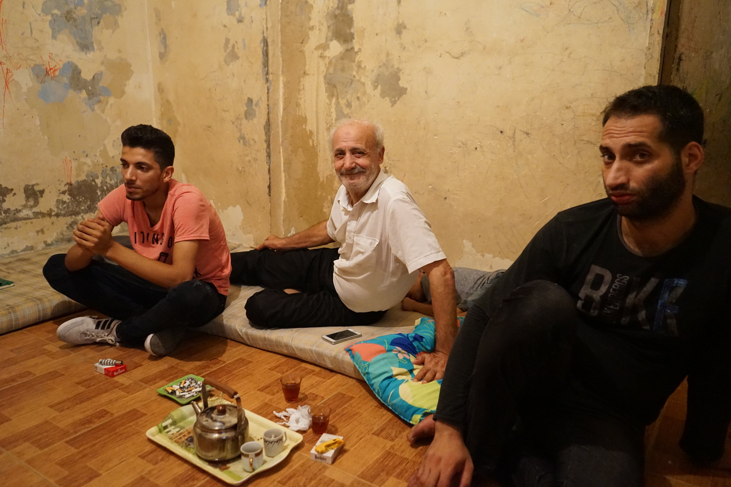  Al Hassan, Ghanam and Ghanam's son (left to right) sit in Ghanam's home in Sabra and Shatila on August 17, 2016. 