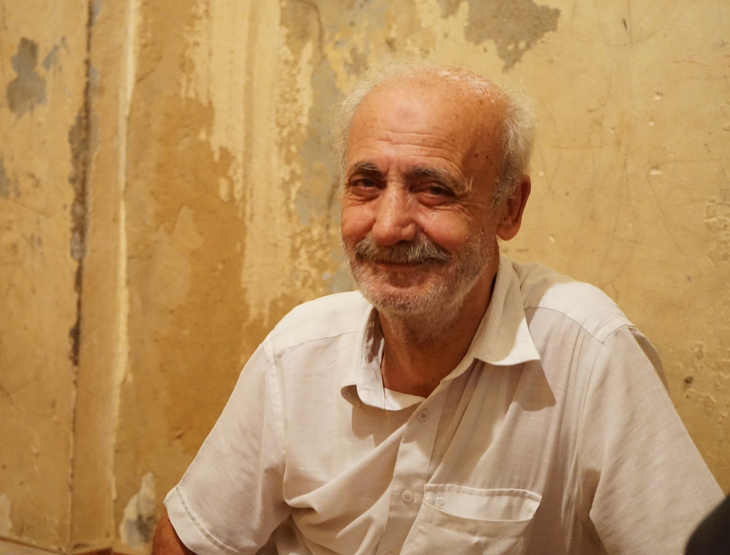  Ghanam smiles for the camera in his home in Sabra and Shatila on August 17, 2016. 