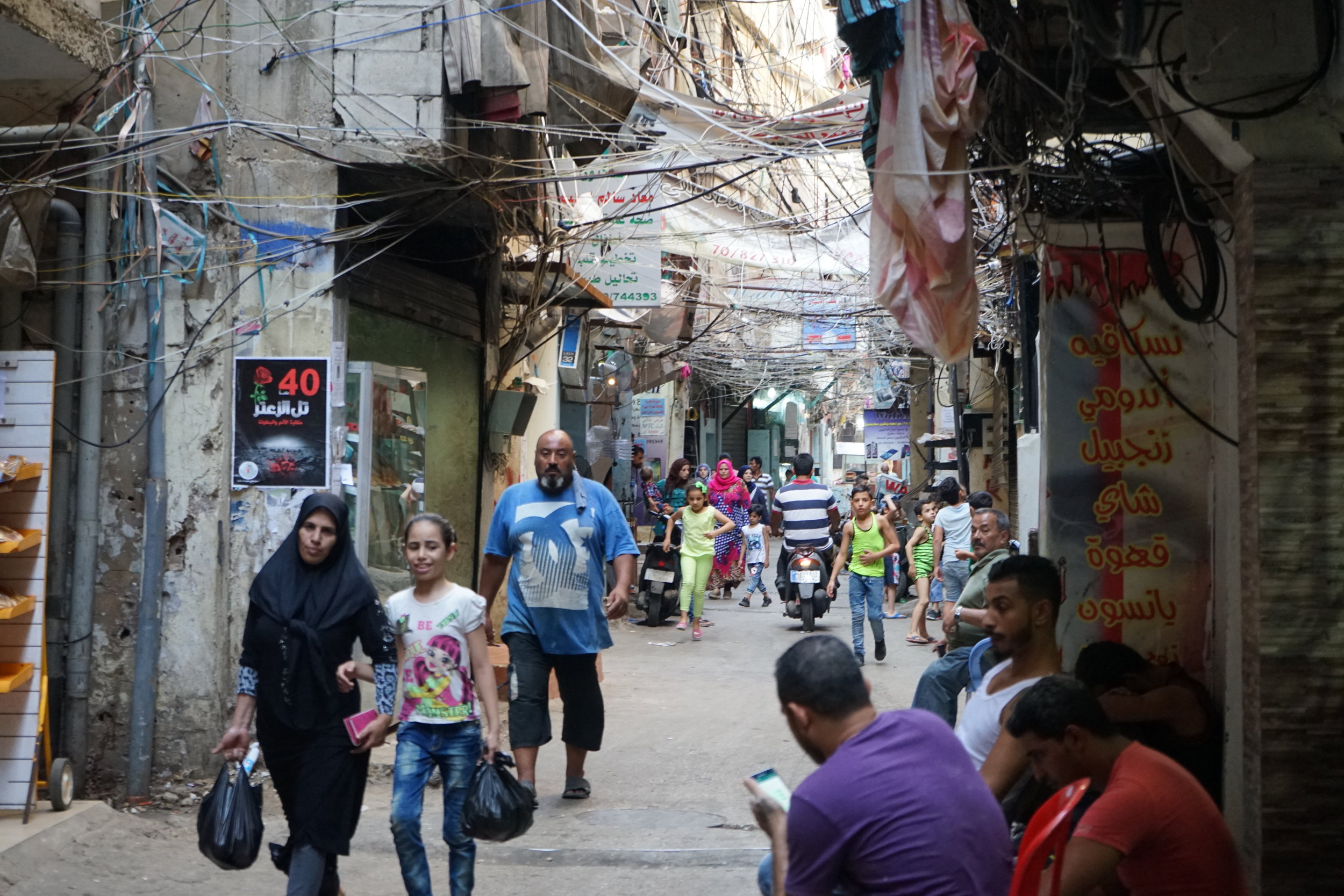  Residents walk through the streets of Sabra and Shatila on August 18, 2016. 