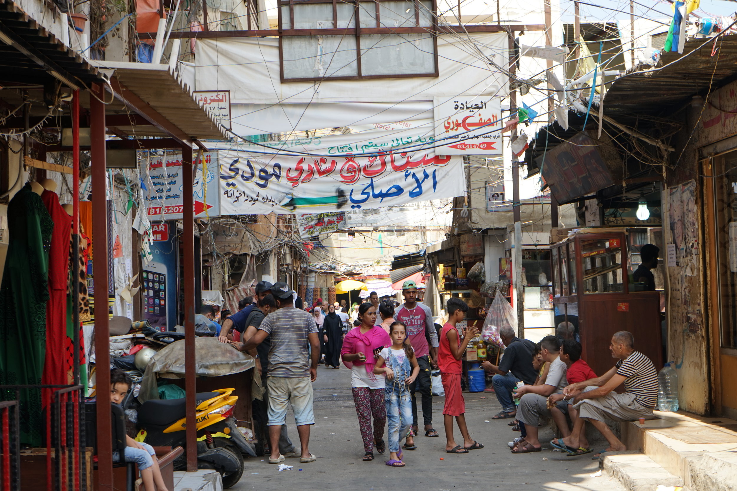  Residents walk through the market in Sabra and Shatila on August 18, 2016. 