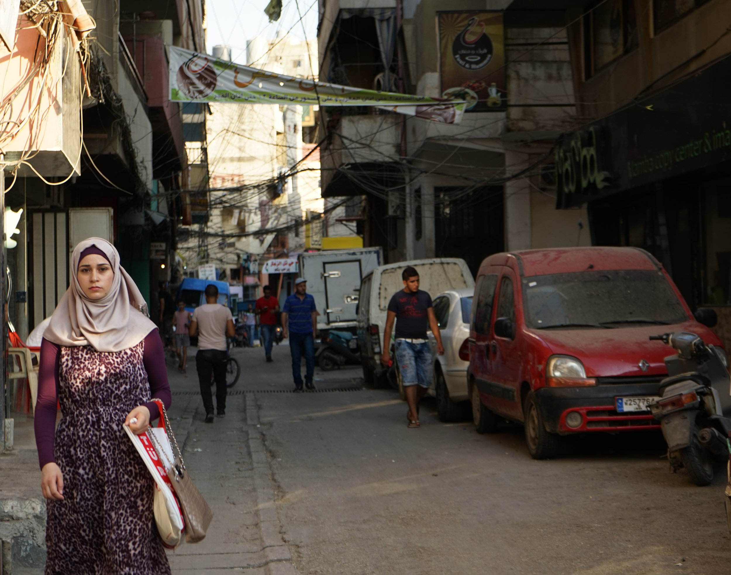  A young woman walks down a street in Camp Beddawi on August 20, 2016. 